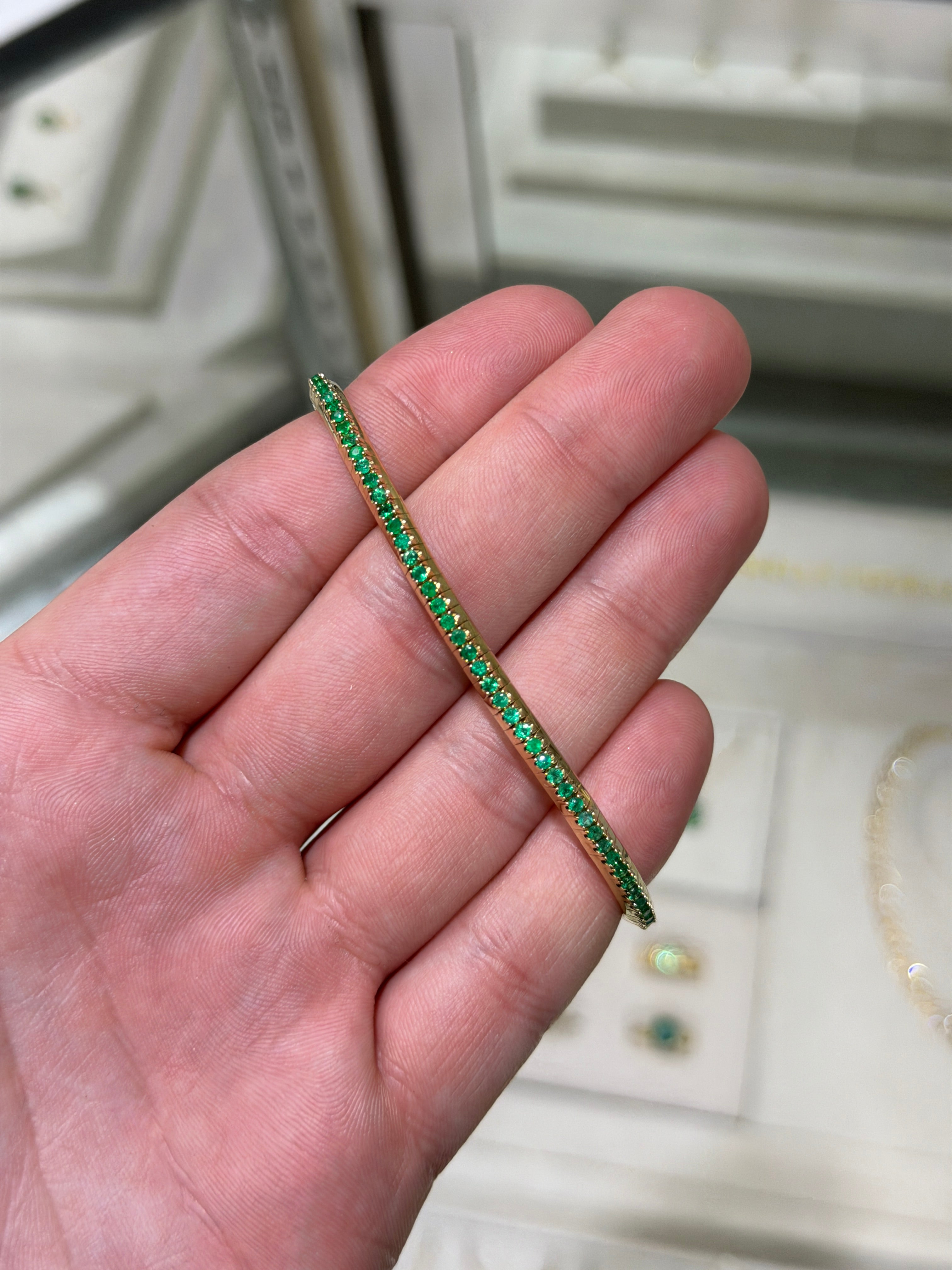 14K gold tennis bracelet with 3.30tcw natural round emeralds, featuring a stretchy design by JR Colombian Emeralds.