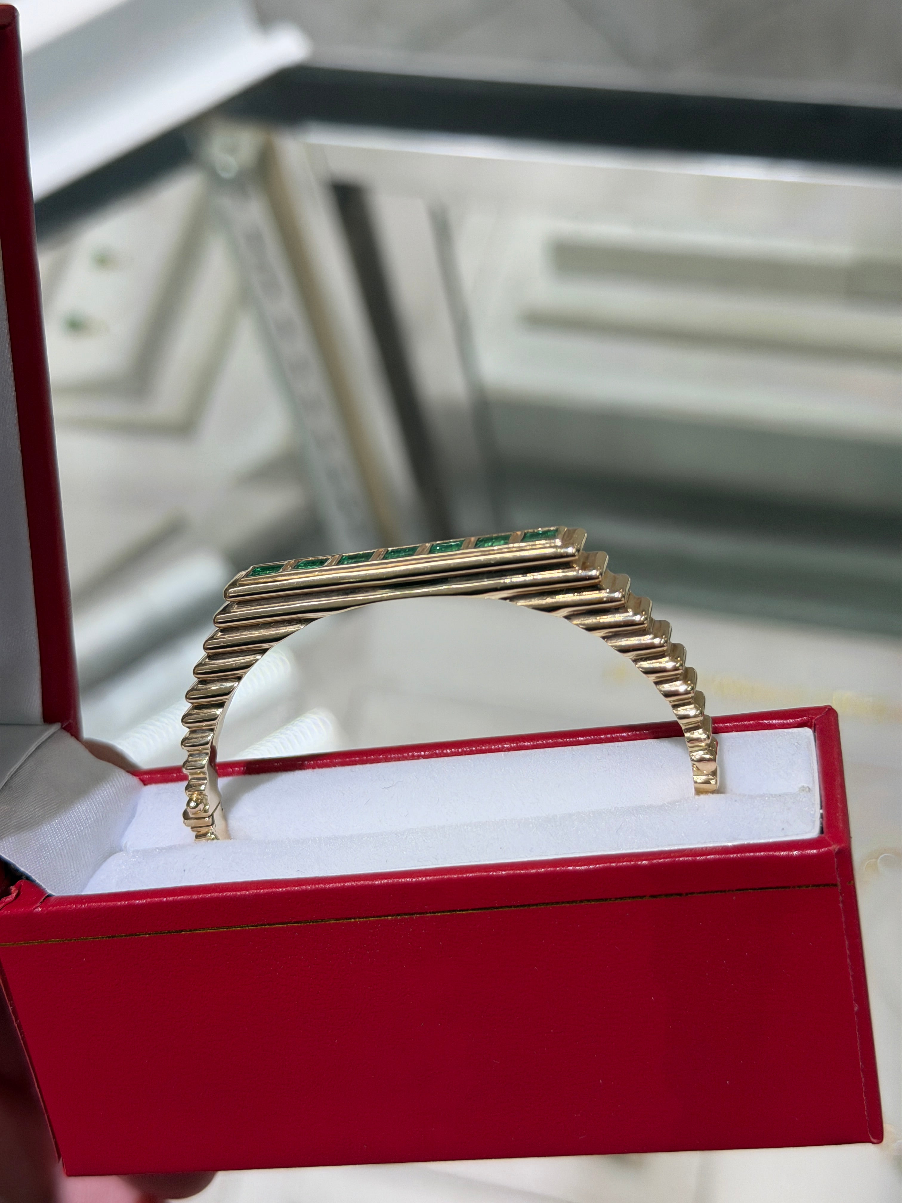 14K gold bangle bracelet with princess cut emeralds, bezel setting, ribbed design, by JR Colombian Emeralds.