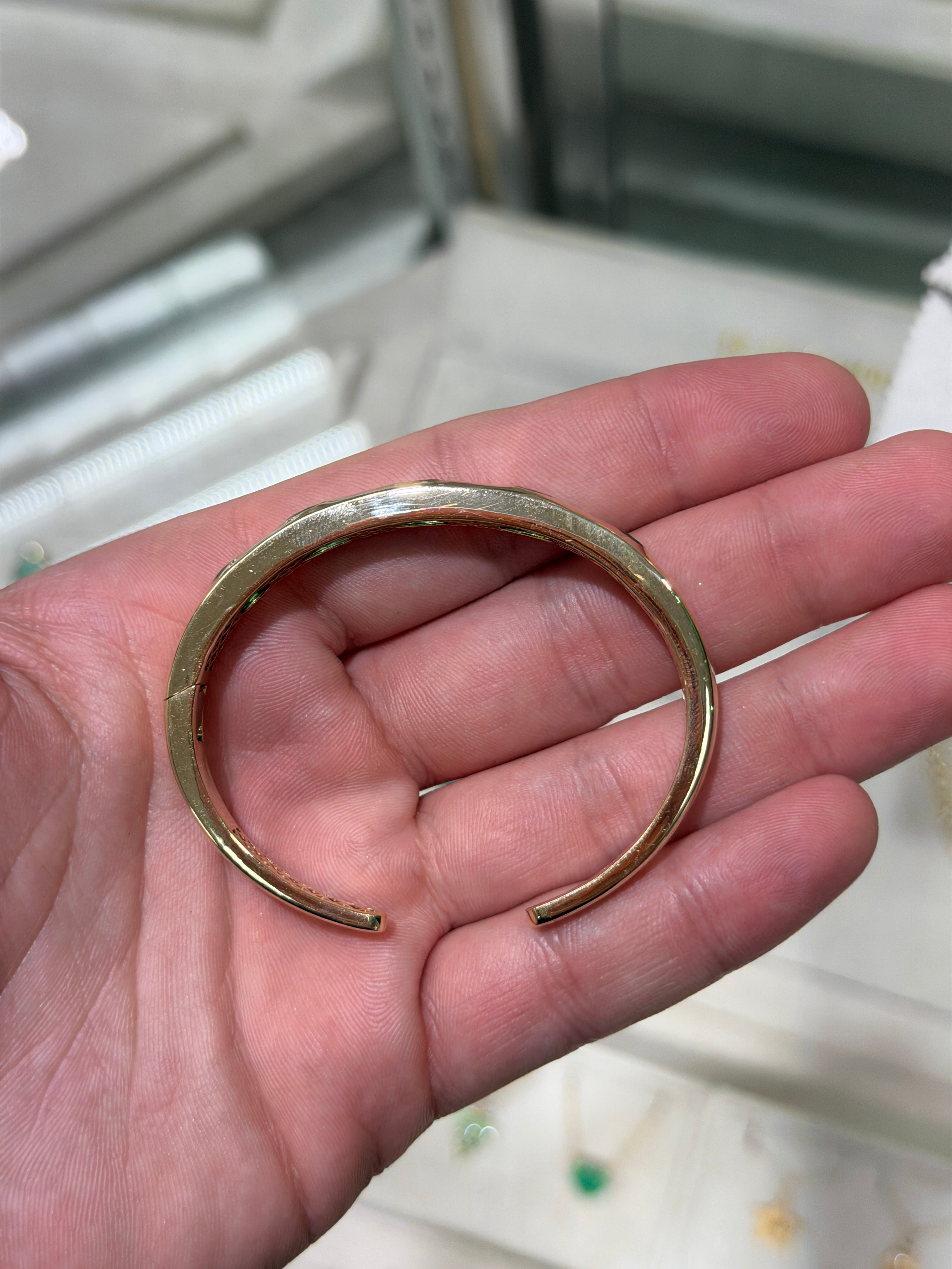 14K green emerald bangle bracelet with pear and oval cut stones, bezel set, by JR Colombian Emeralds.