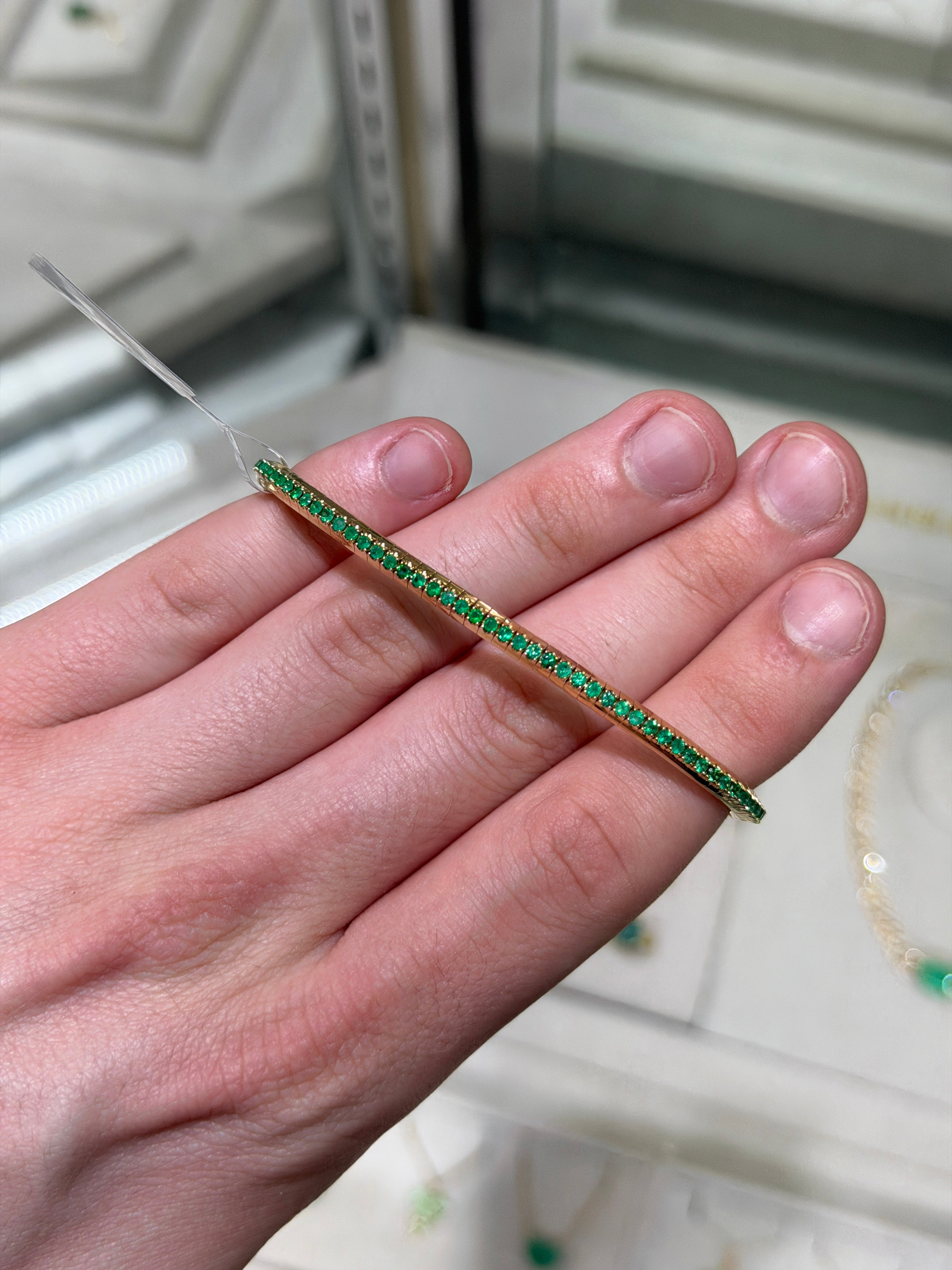 14K gold tennis bracelet with round emeralds totaling 3.30 carats, featuring a stretchy design and natural all-round emeralds.