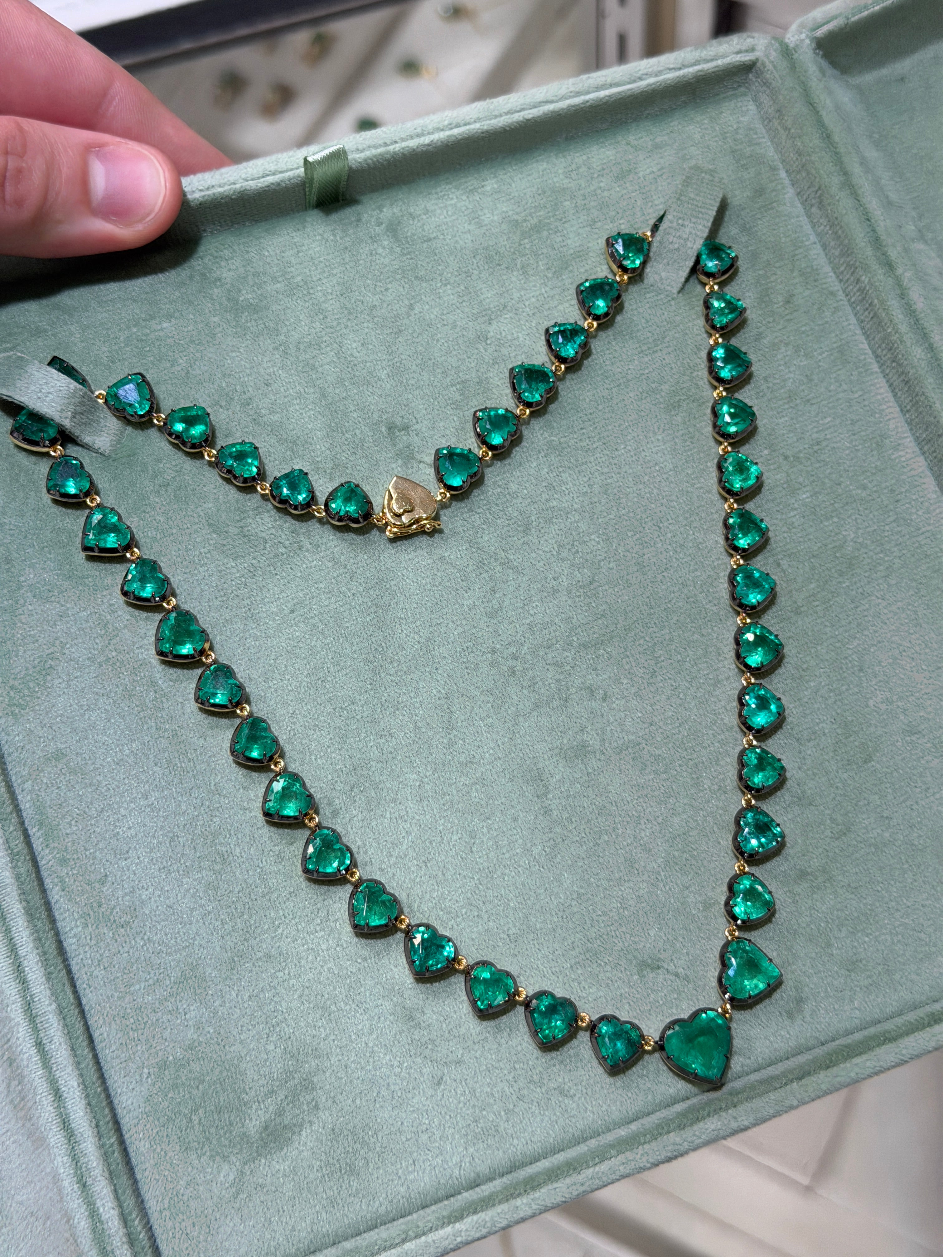 14K gold heart-shaped emerald tennis necklace with black rhodium, 60.98 carats, 18-inch length by JR Colombian Emeralds.