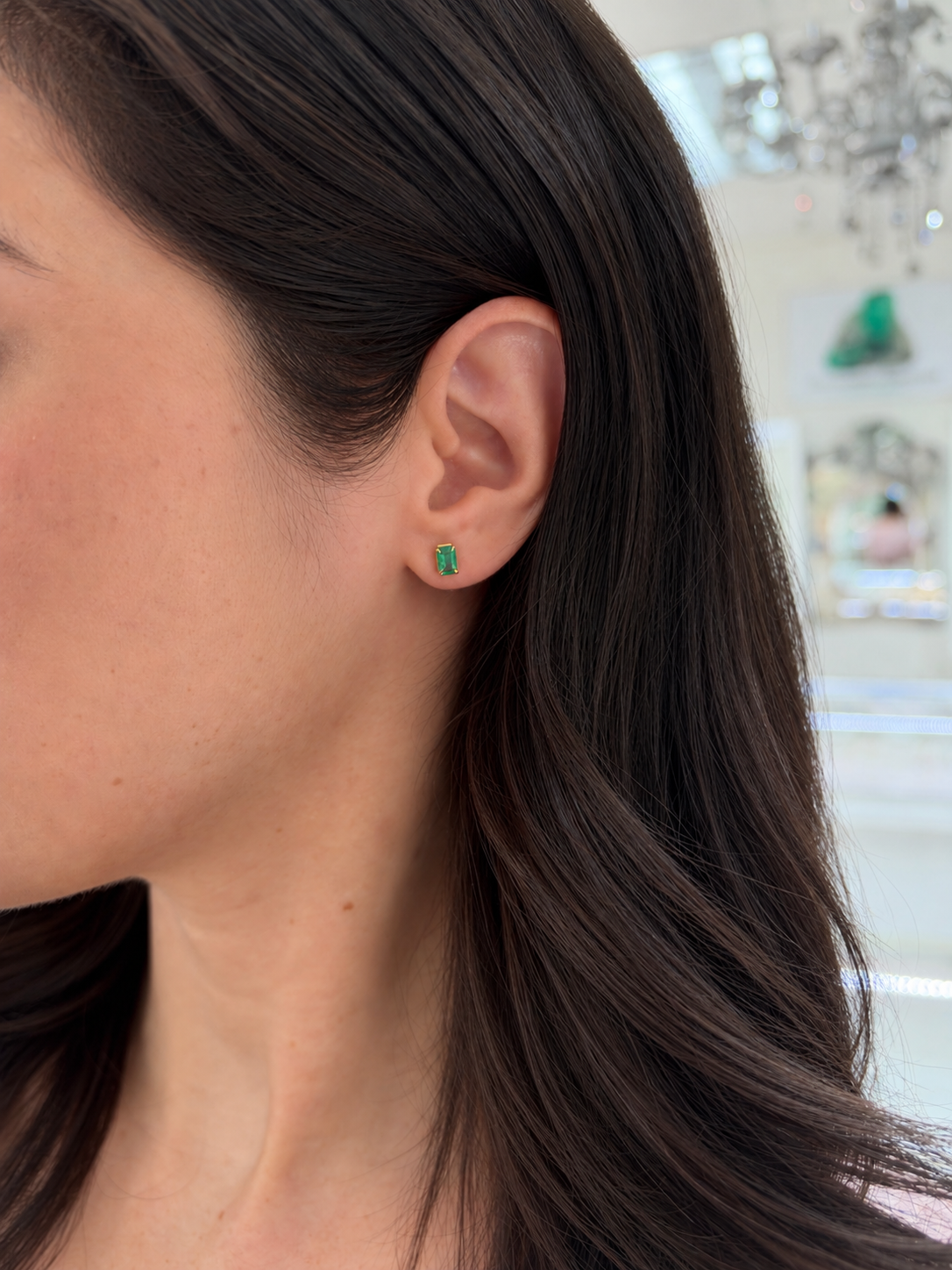 Medium green Zambian emerald cut stud earrings with 1.0tcw total weight in 14K gold, featuring elegant emerald gemstones.