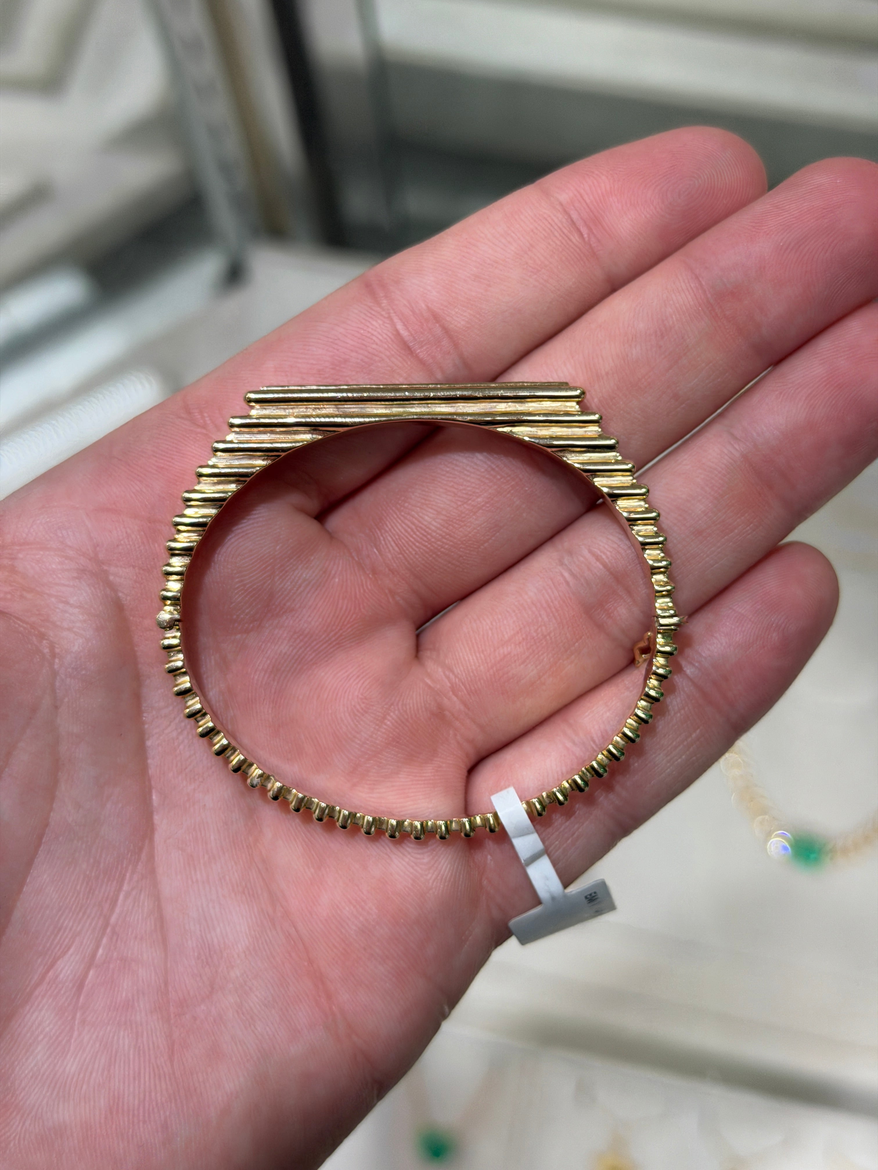 14K gold bangle bracelet with 1.64tcw princess cut emeralds and ribbed design, bezel set by JR Colombian Emeralds.