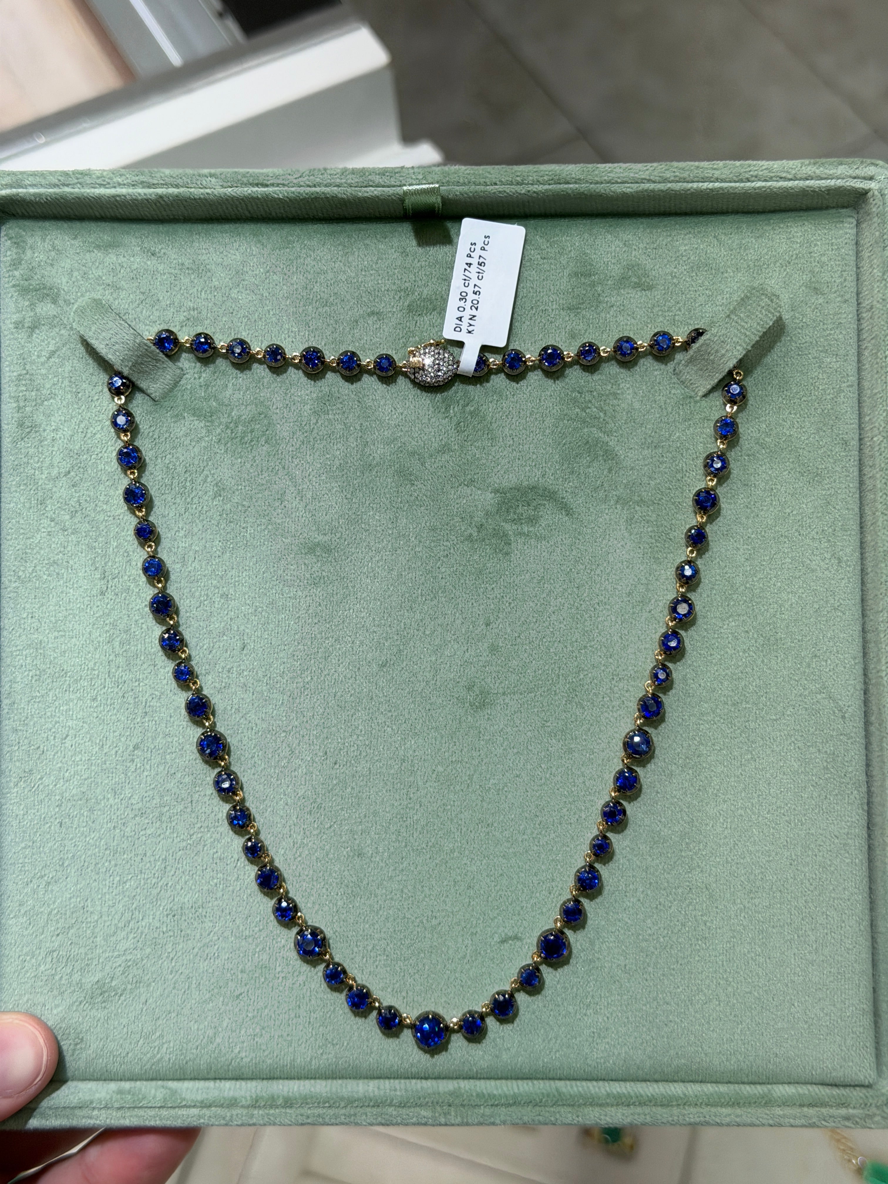 14K gold necklace featuring deep blue Kyanite round cut stones and a diamond clasp, 17-inch length, by JR Colombian Emeralds.
