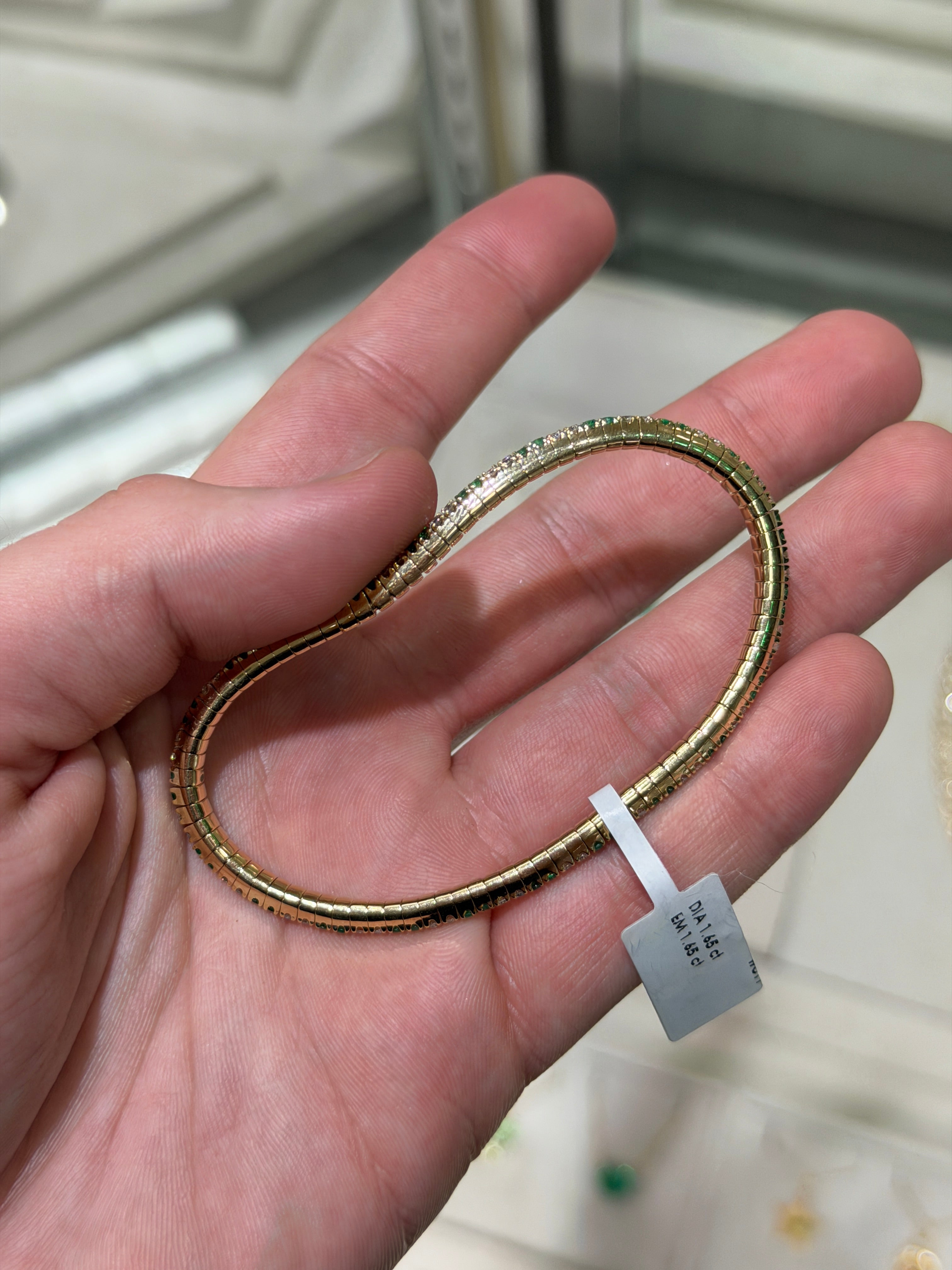 14K gold tennis bracelet with alternating natural emeralds and diamonds, prong set, showcasing a stretchy design by JR Colombian Emeralds.