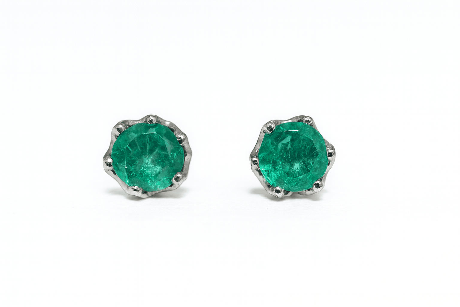 Six prong round cut emerald stud earrings in 14K white gold