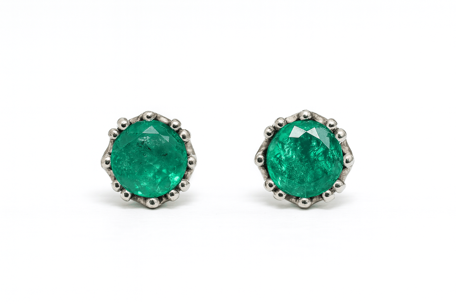 1.50tcw round emerald multiprong stud earrings in 14K white gold with medium light bluish green stones