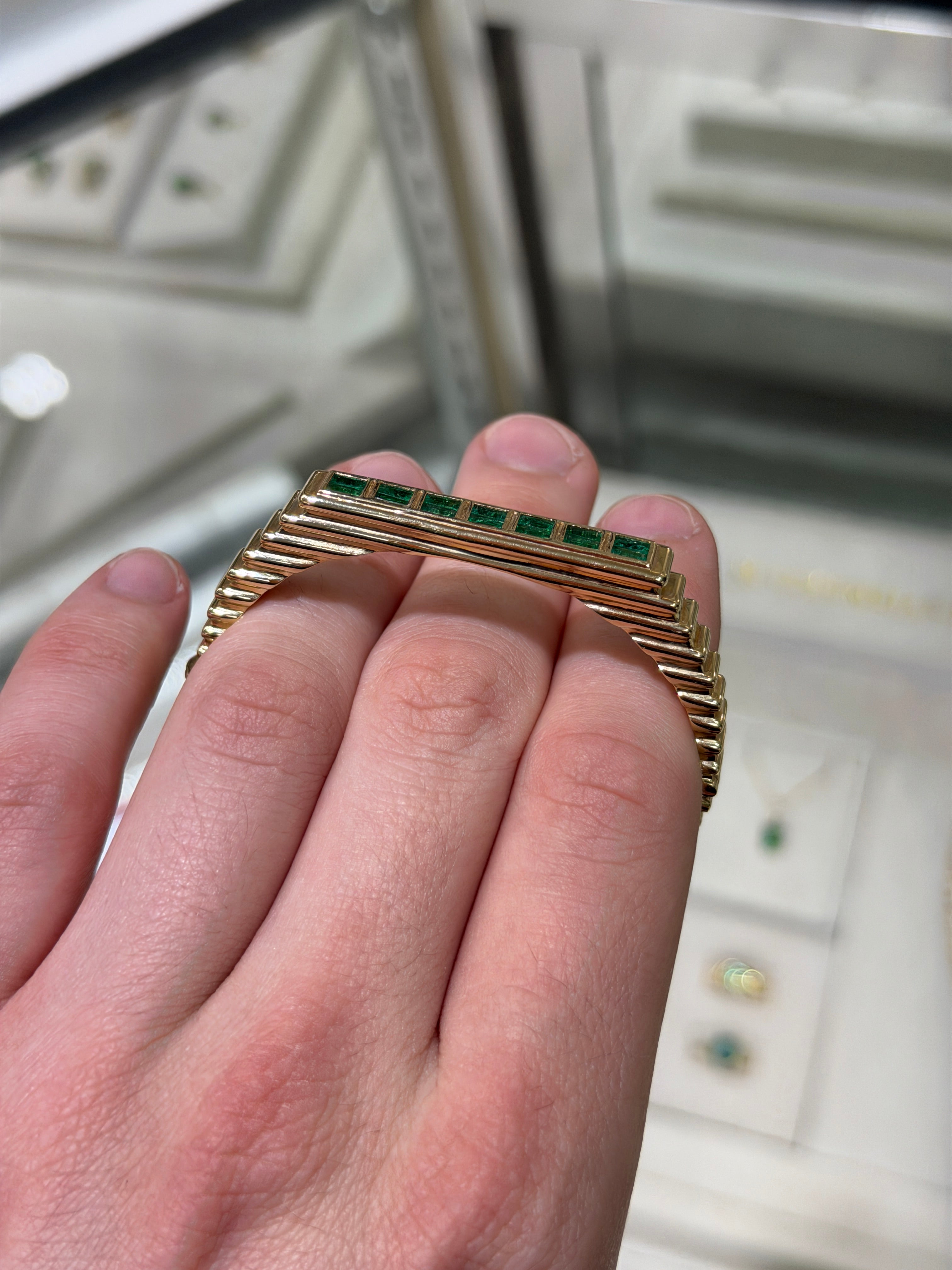 14K gold bangle bracelet featuring 1.64ctw princess cut emeralds with bezel setting and ribbed design, by JR Colombian Emeralds.