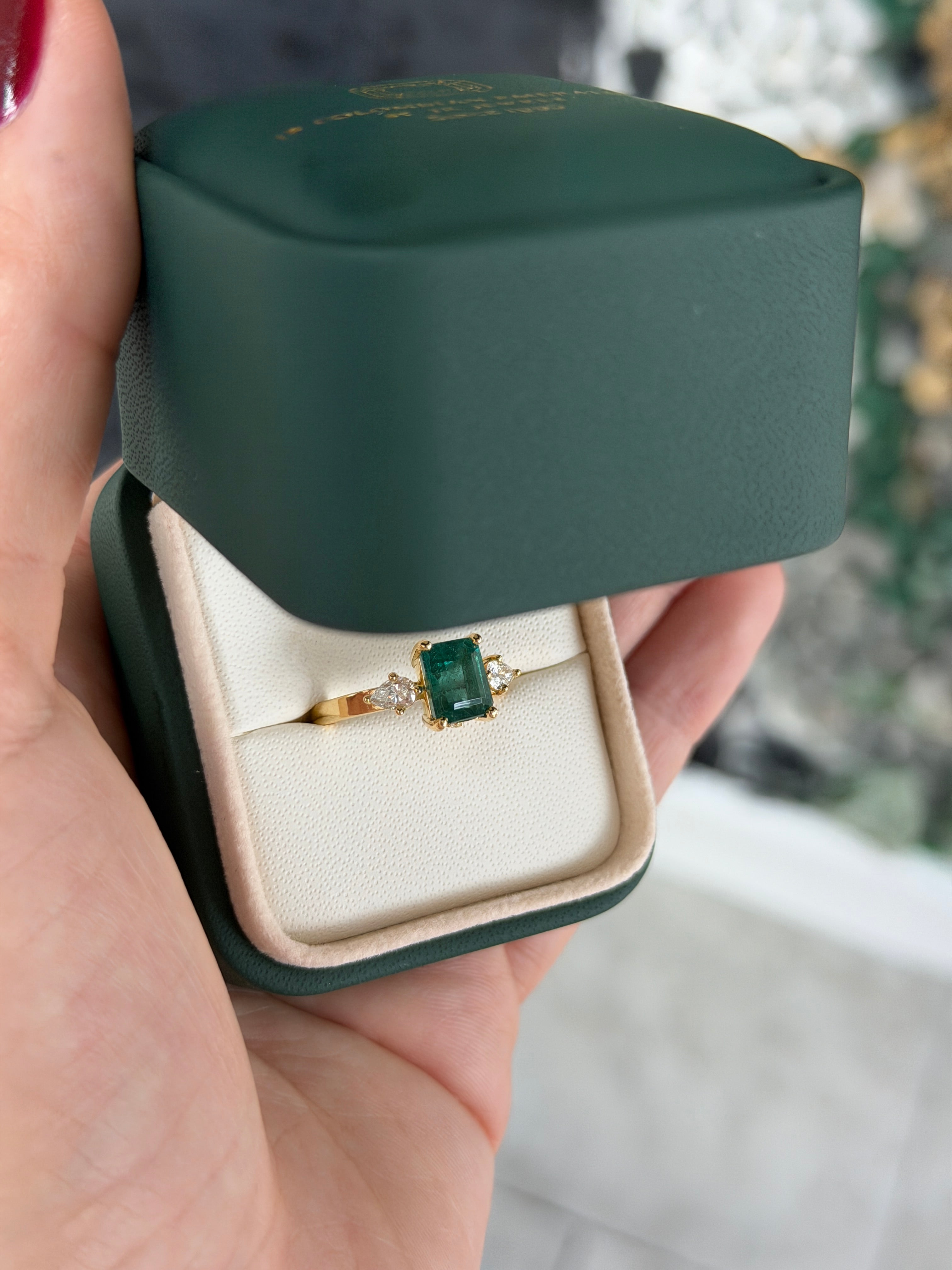 Emerald cut emerald and pear-shaped diamonds three stone ring with hidden diamond accents in 18K gold by JR Colombian Emeralds