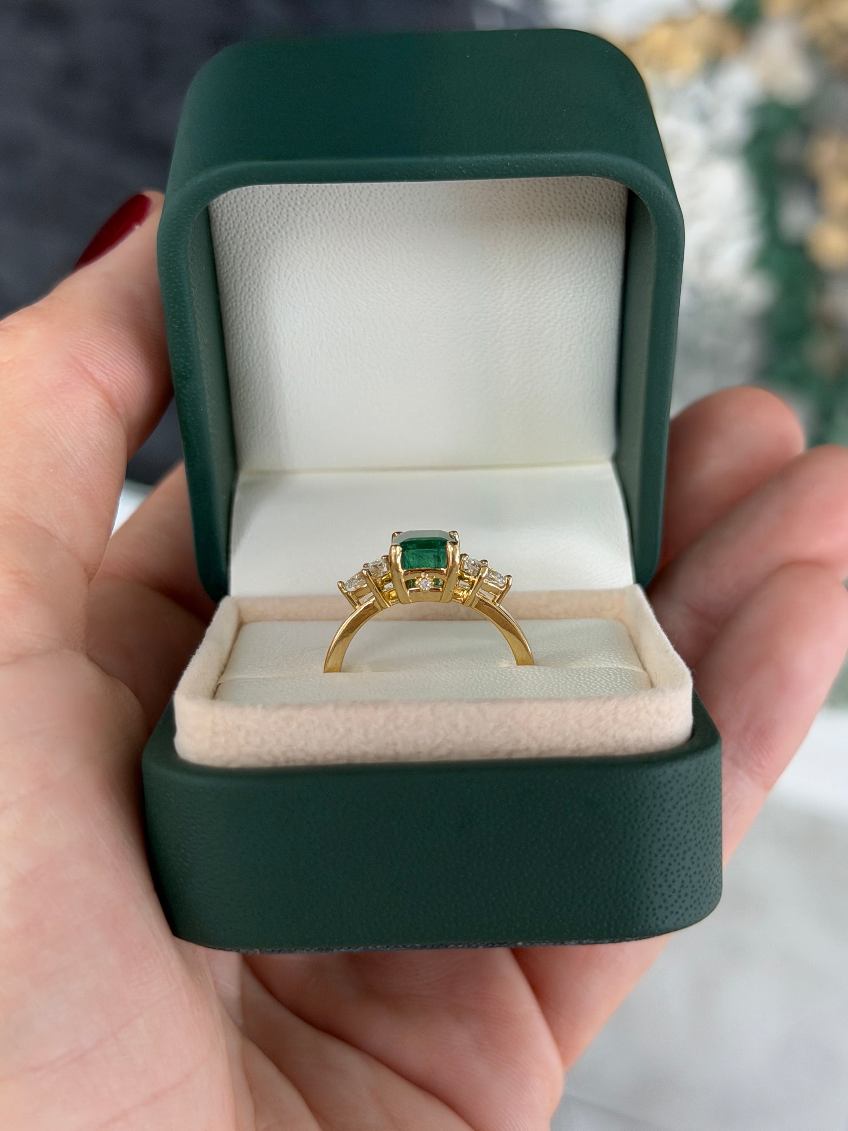 Emerald cut emerald and pear-shaped diamond three-stone ring with hidden diamond accents in 18K gold by JR Colombian Emeralds.