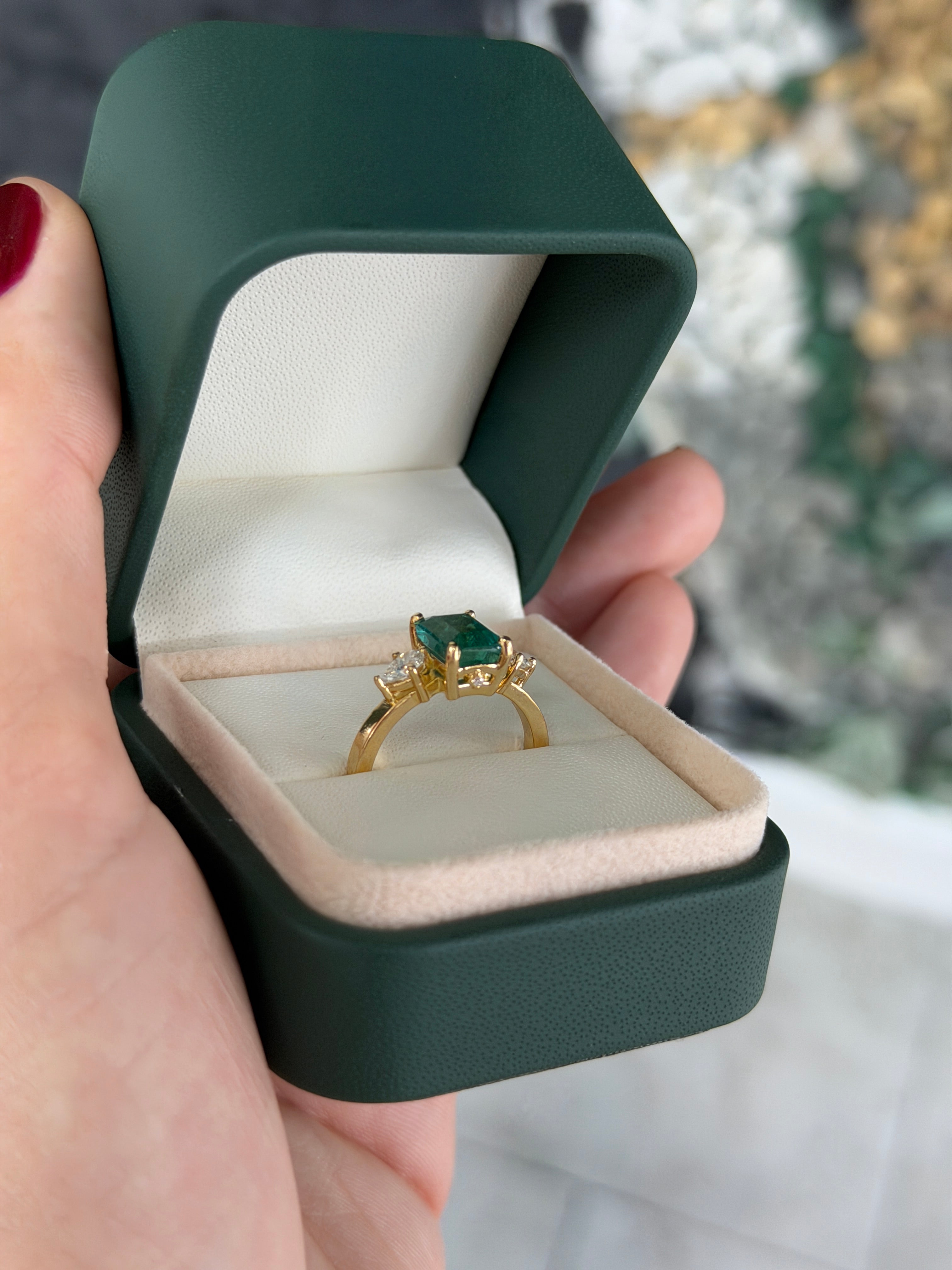 Emerald cut emerald and pear-shaped diamond three-stone ring with hidden diamond accents in 18K gold by JR Colombian Emeralds.