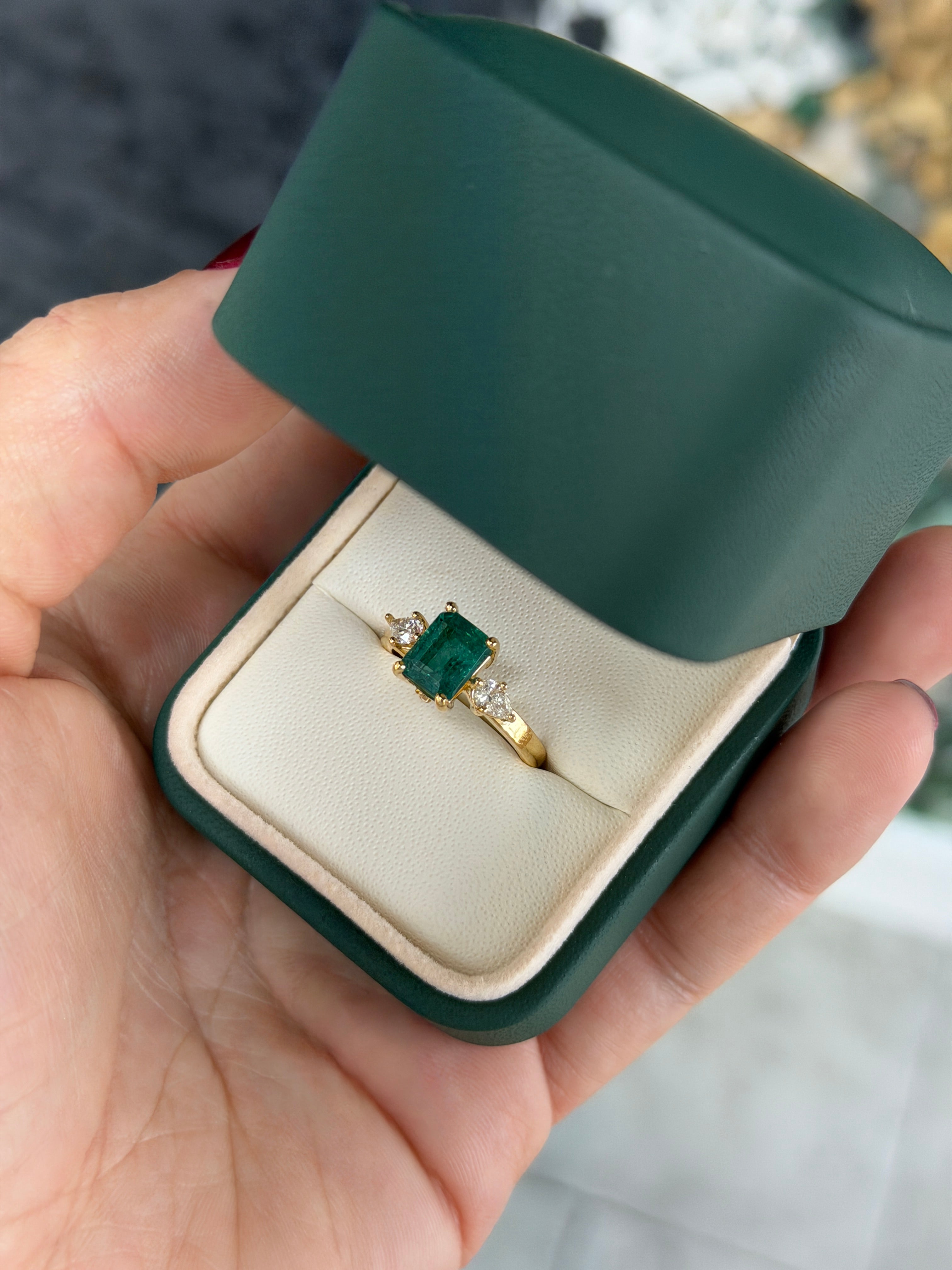 Emerald cut emerald and pear-shaped diamond three-stone ring with hidden diamond accents in 18K gold by JR Colombian Emeralds