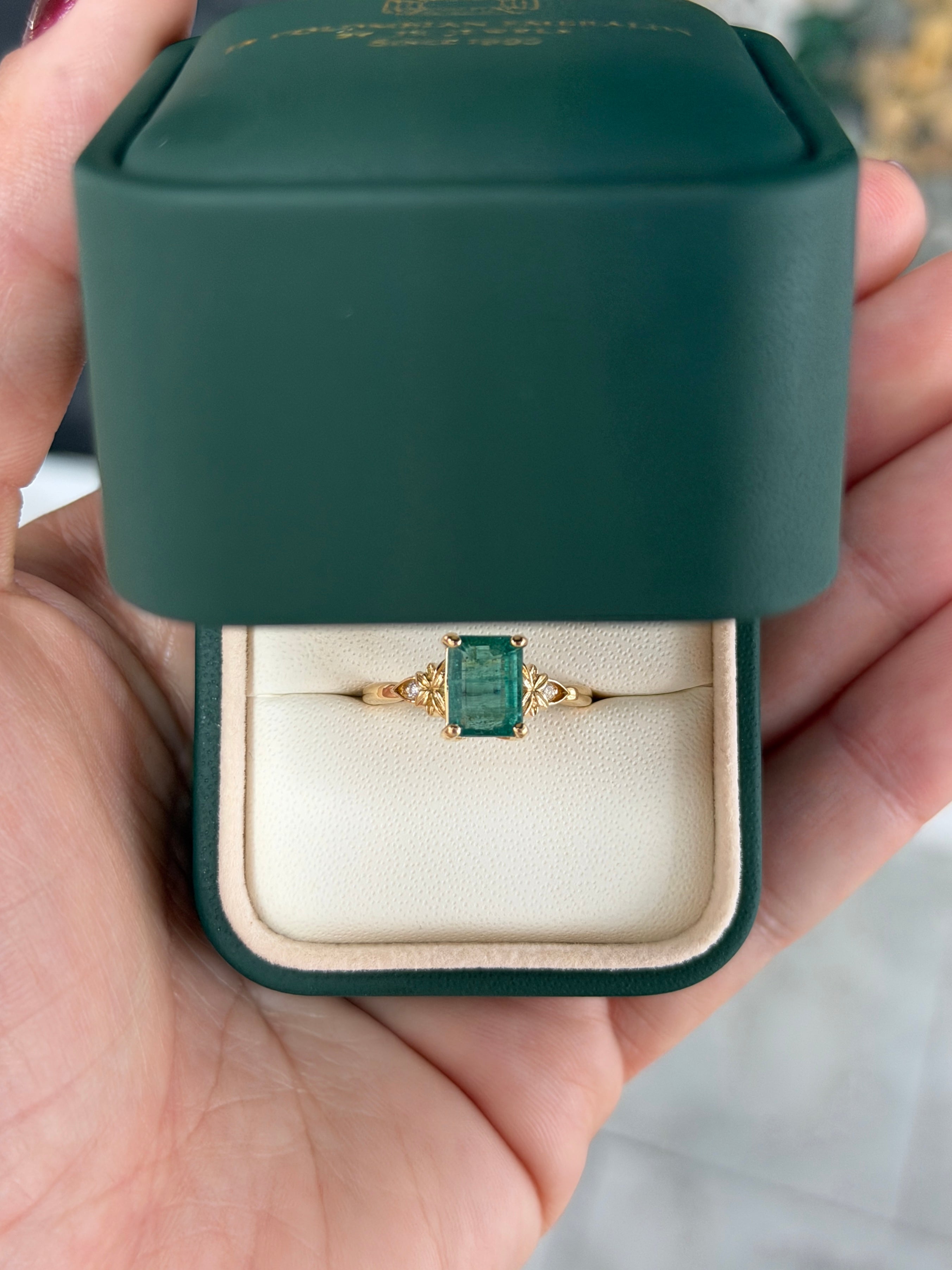 Anello solitario in oro 14 carati con smeraldo, impreziosito da diamanti sintetici per un totale di 2,30 carati, caratterizzato da una gemma centrale di smeraldo e da dettagli raffinati.