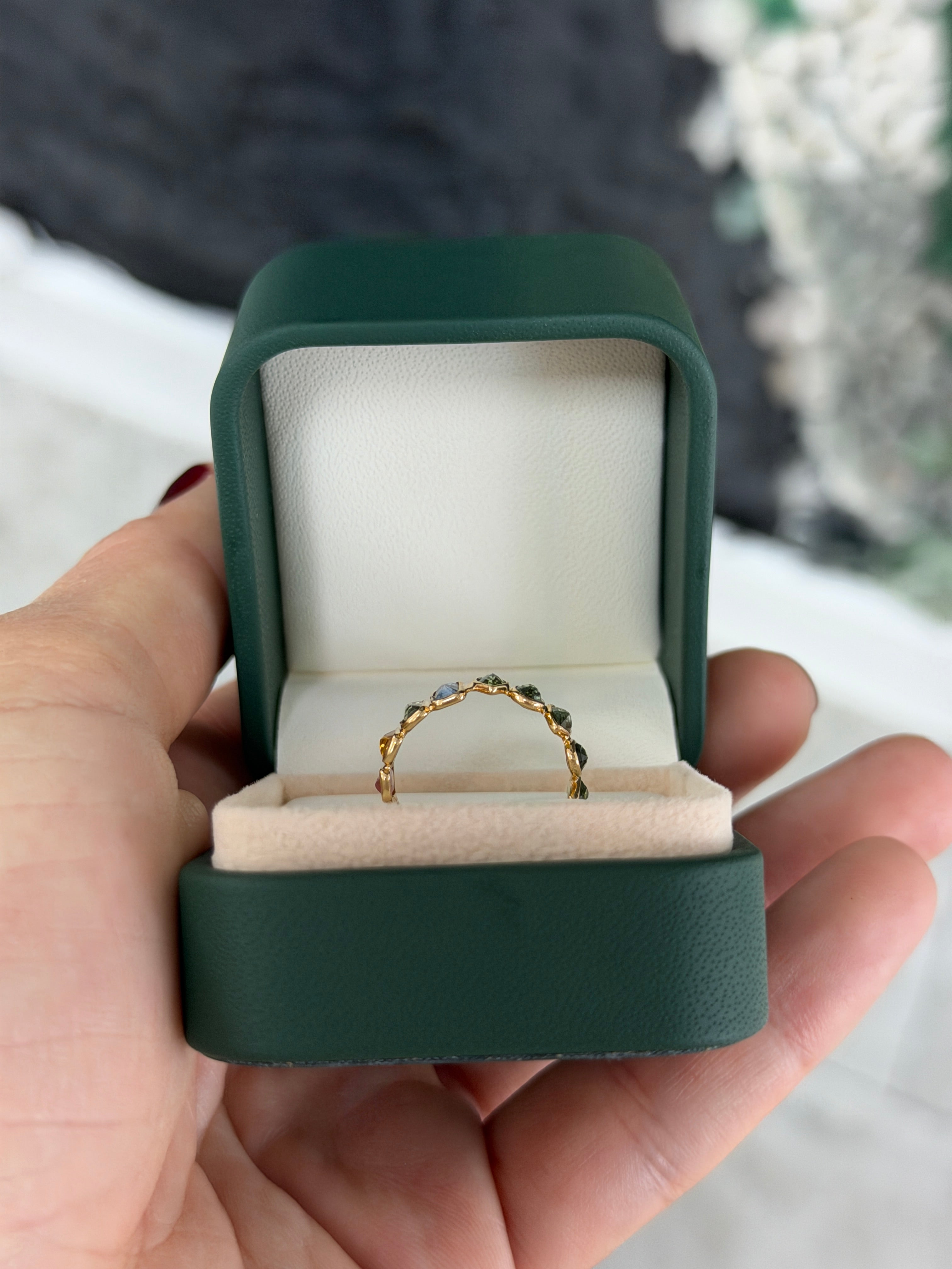 18K gold rainbow sapphire eternity band featuring pastel-colored sapphires in a low-profile design, size 6.5, by JR Colombian Emeralds.