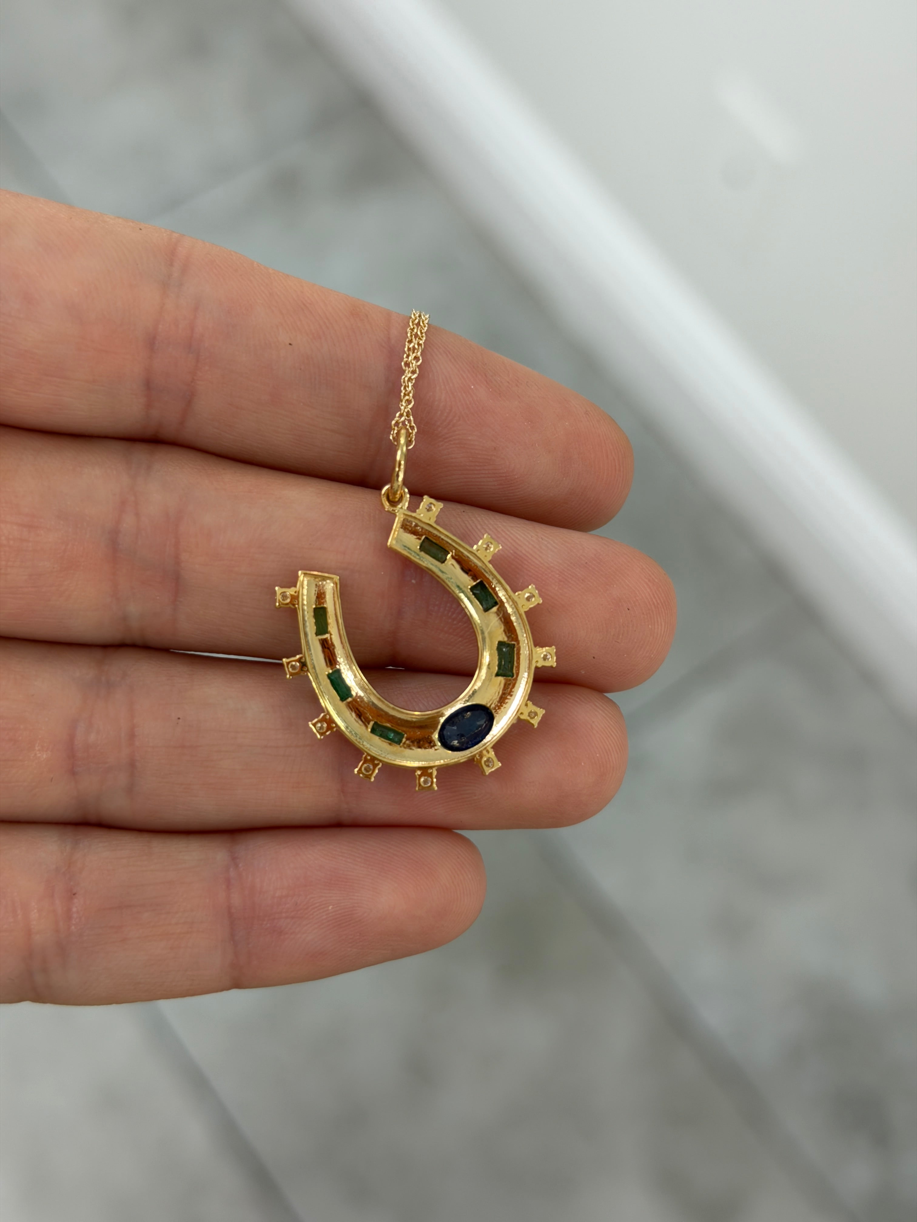 14K gold horseshoe charm pendant with 1.26tcw natural sapphire, emerald, and diamond accents from JR Colombian Emeralds.