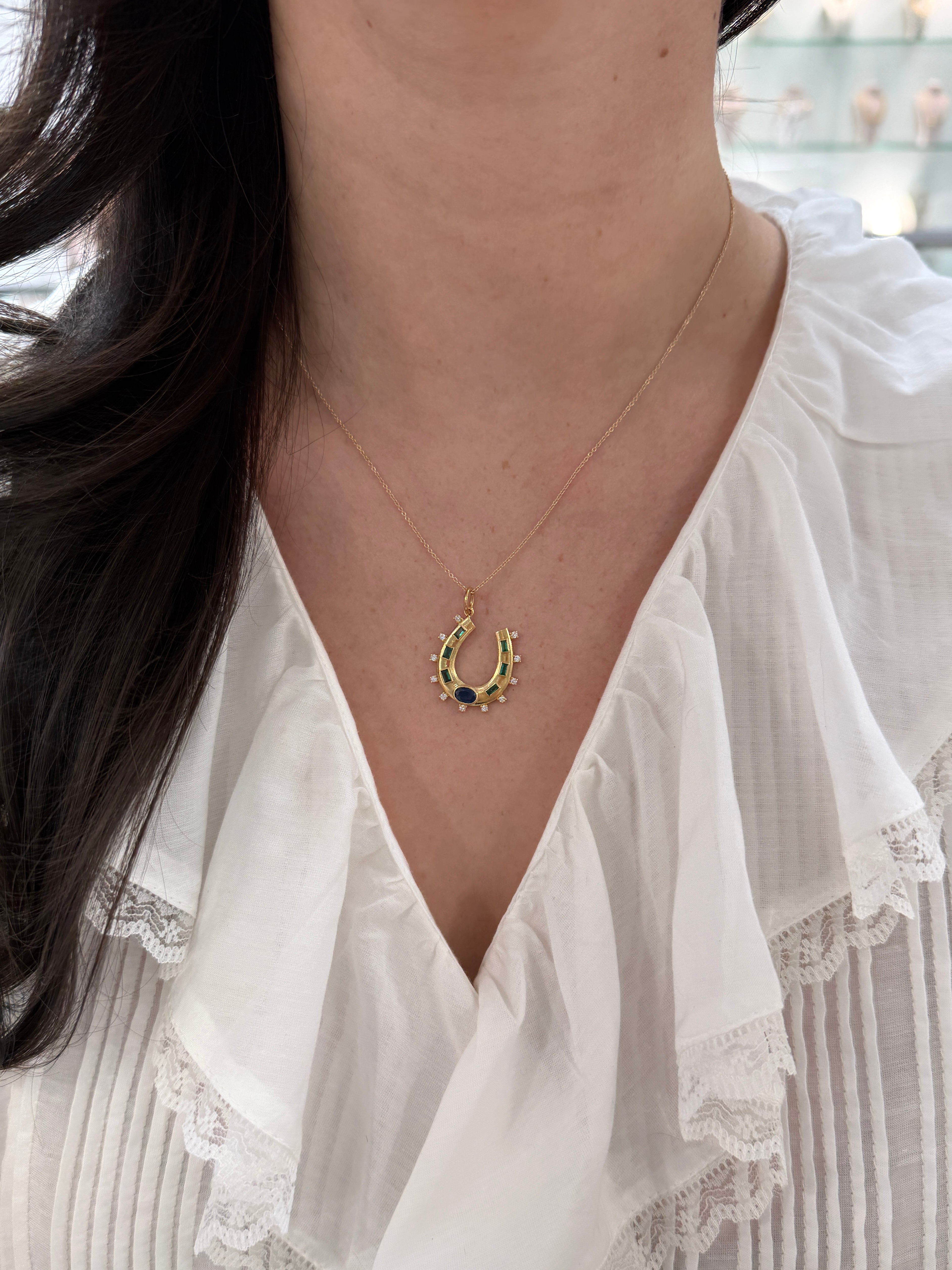 14K gold horseshoe charm pendant with 1.26tcw natural sapphire, emerald, and diamond accents, from JR Colombian Emeralds.