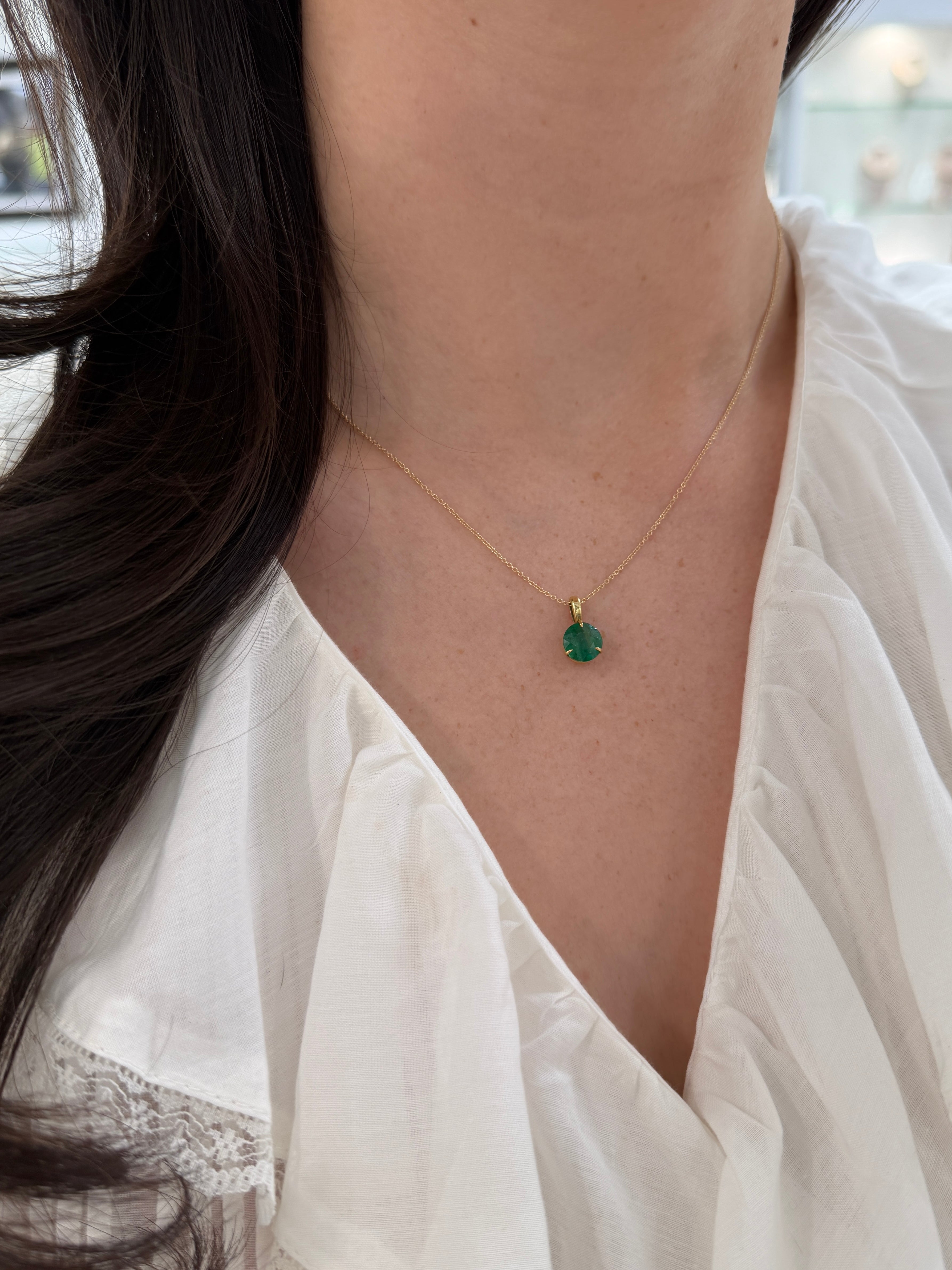 Three-prong round emerald solitaire necklace featuring a 1.66ct emerald, set in 14K gold by JR Colombian Emeralds.
