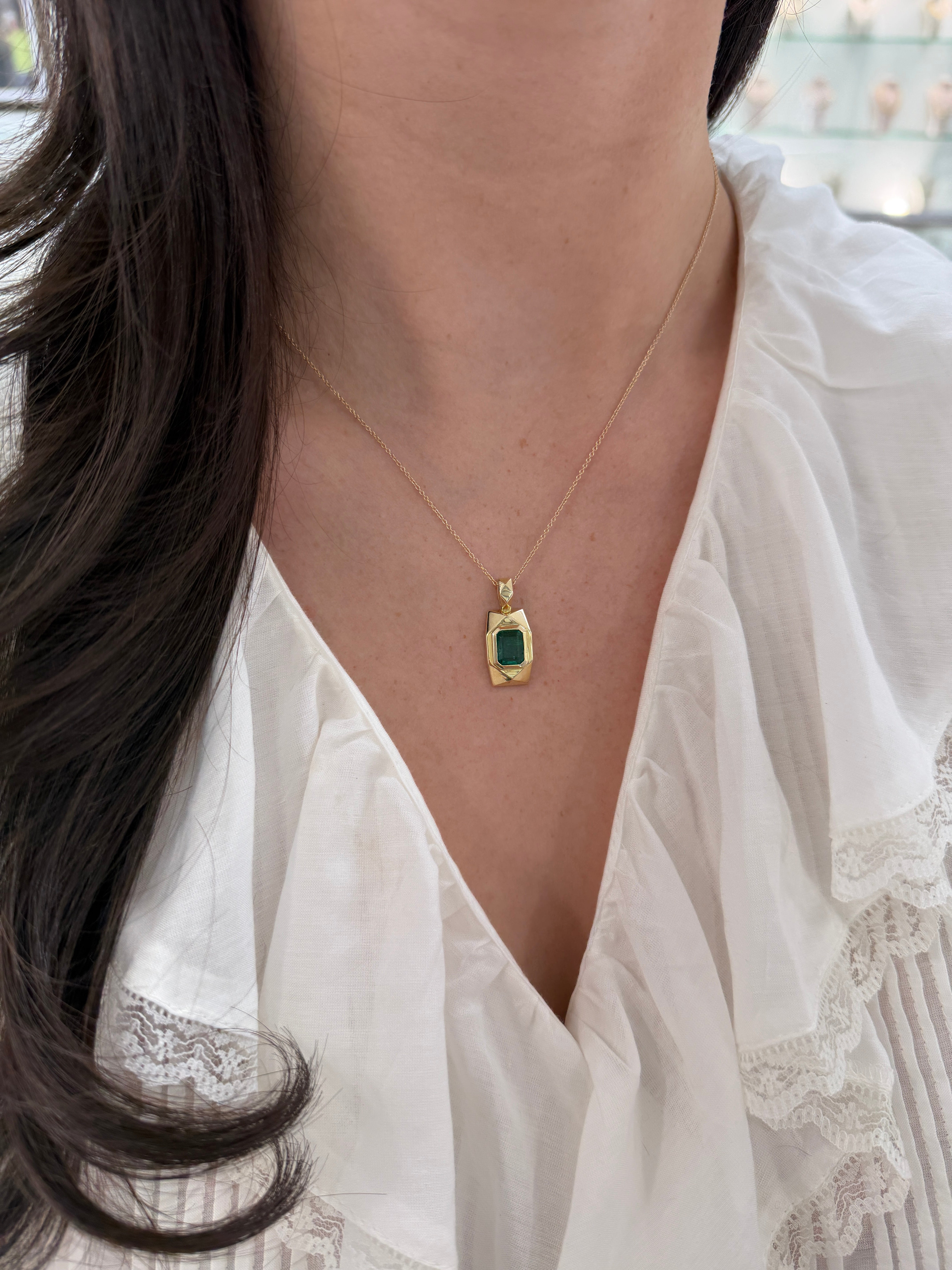 14K gold emerald dog tag pendant with 2.35 carats of vibrant Colombian emeralds, featuring a sleek and polished design.