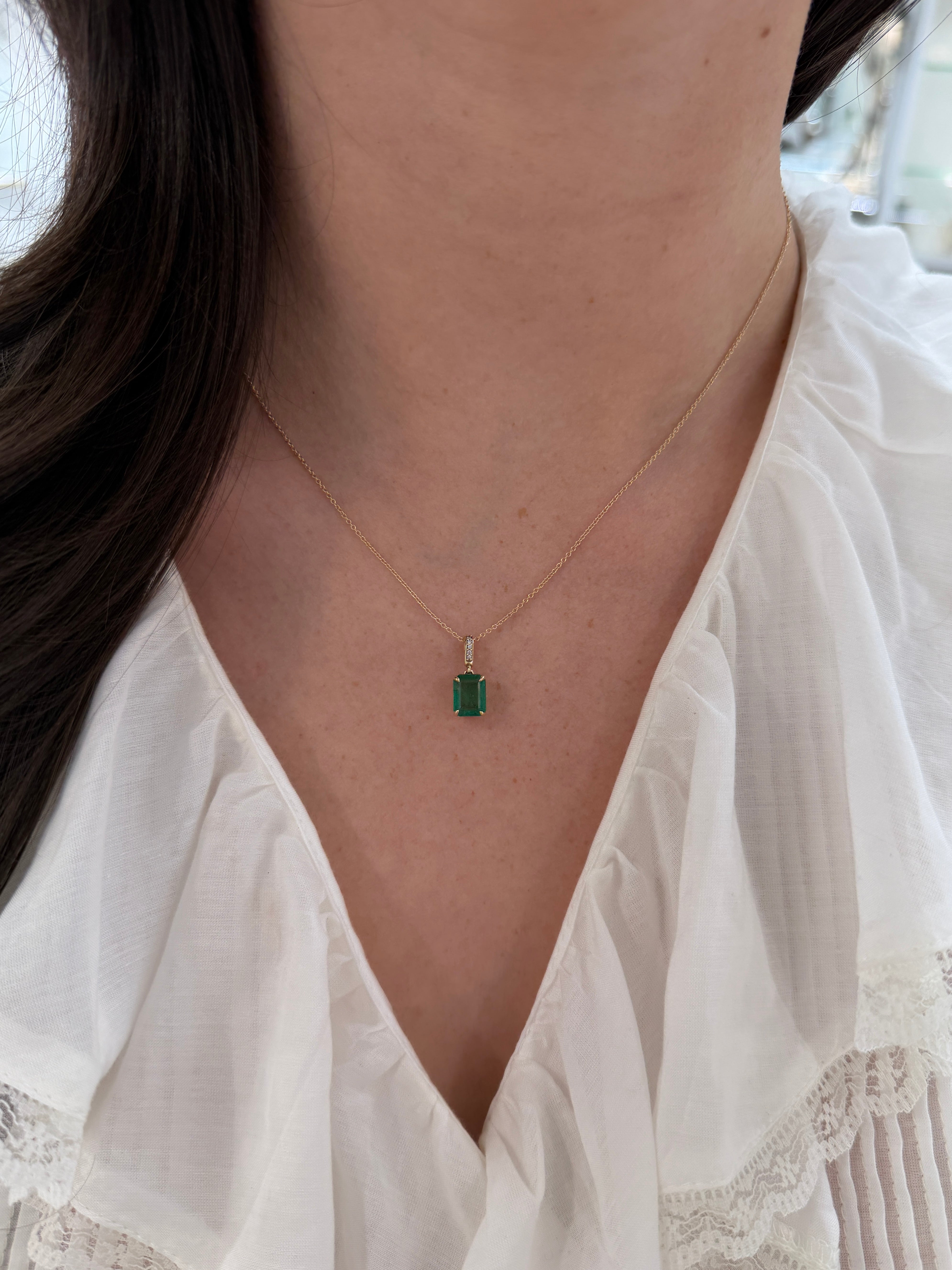 Emerald cut emerald pendant with diamond bail in 14K gold, featuring a 1.79 carat Colombian emerald, by JR Colombian Emeralds