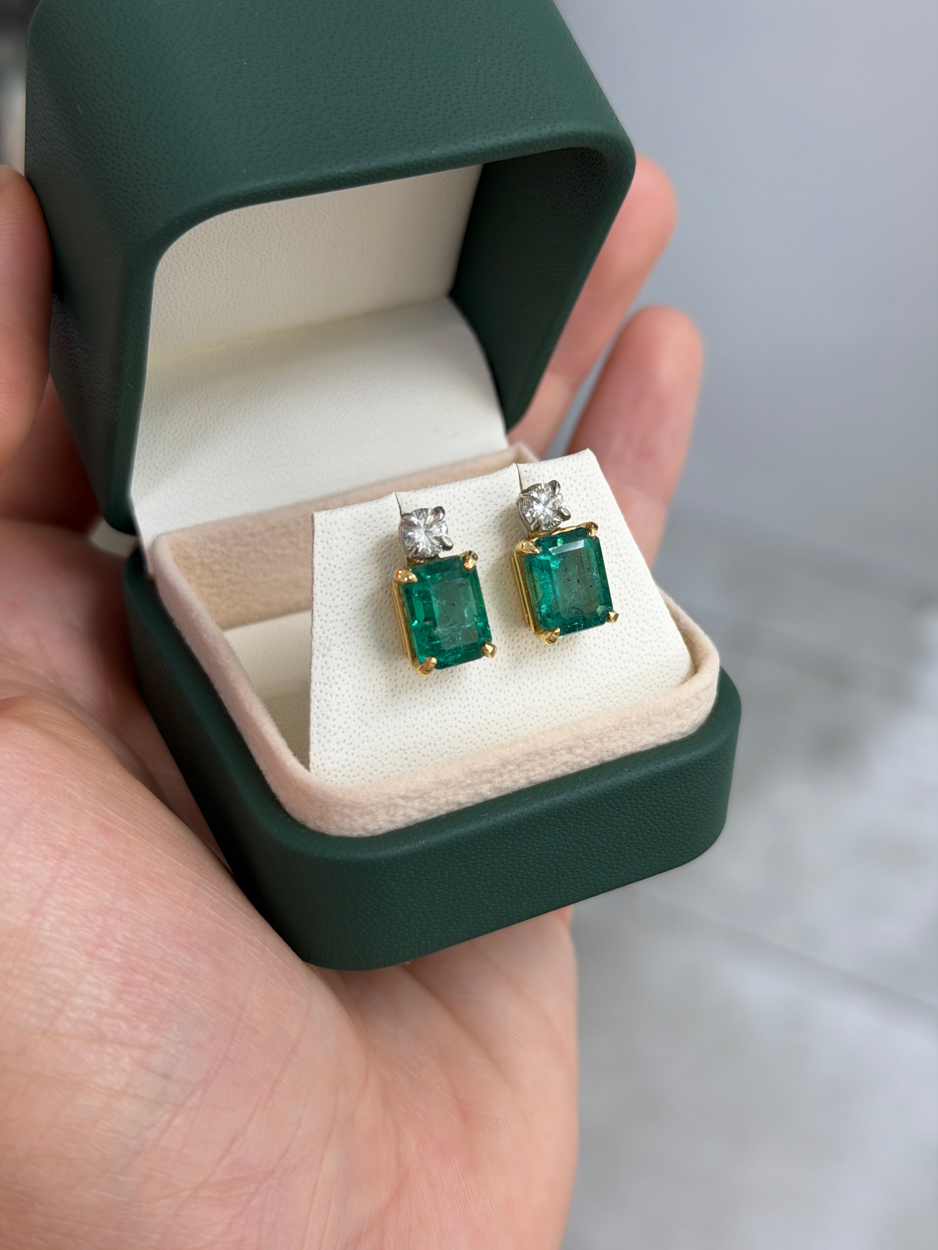Colombian Emerald 18K gold earrings featuring vivid sea green emerald-cut and round diamonds in a two-tone design.
