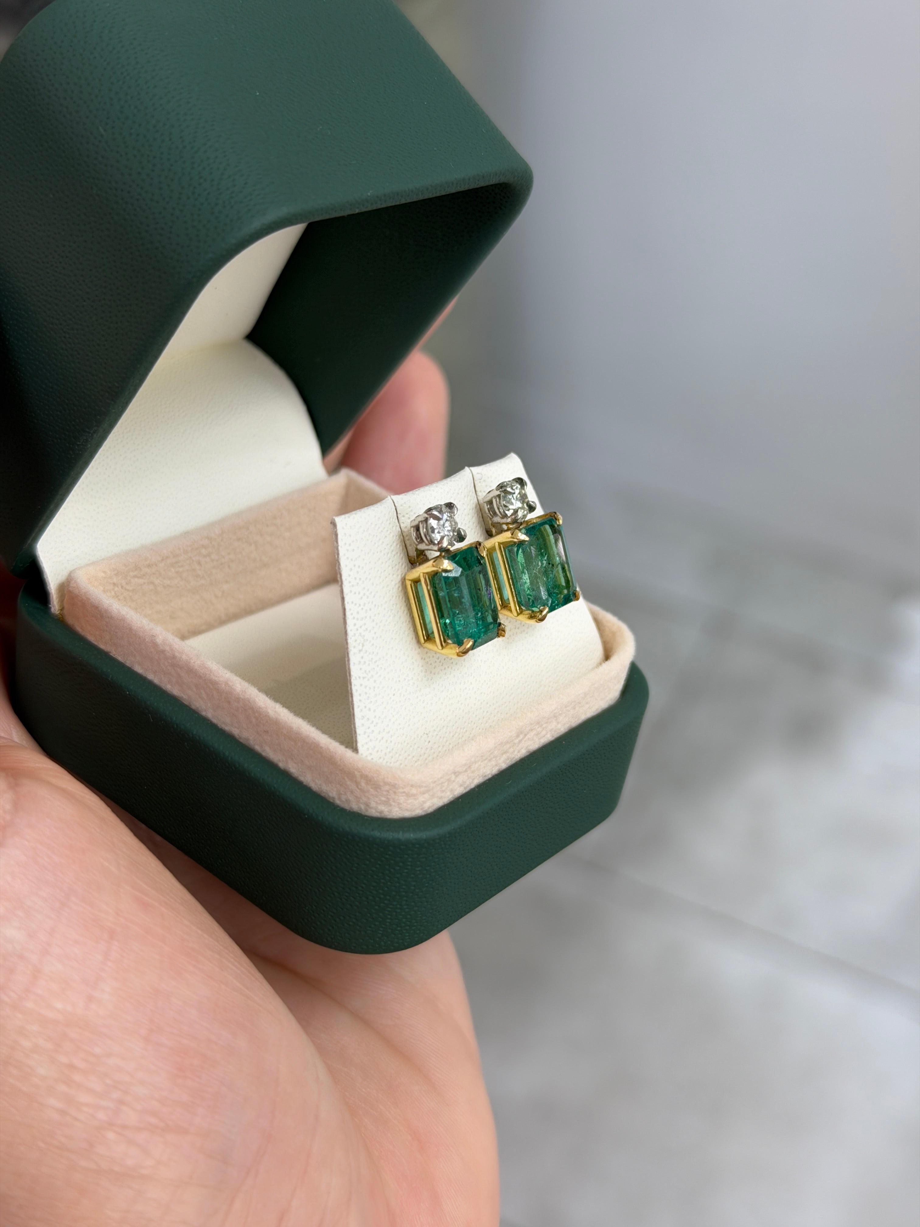 Colombian Emerald 18K gold earrings with vivid sea green emerald-cut and round diamonds, two-tone design, stud style.