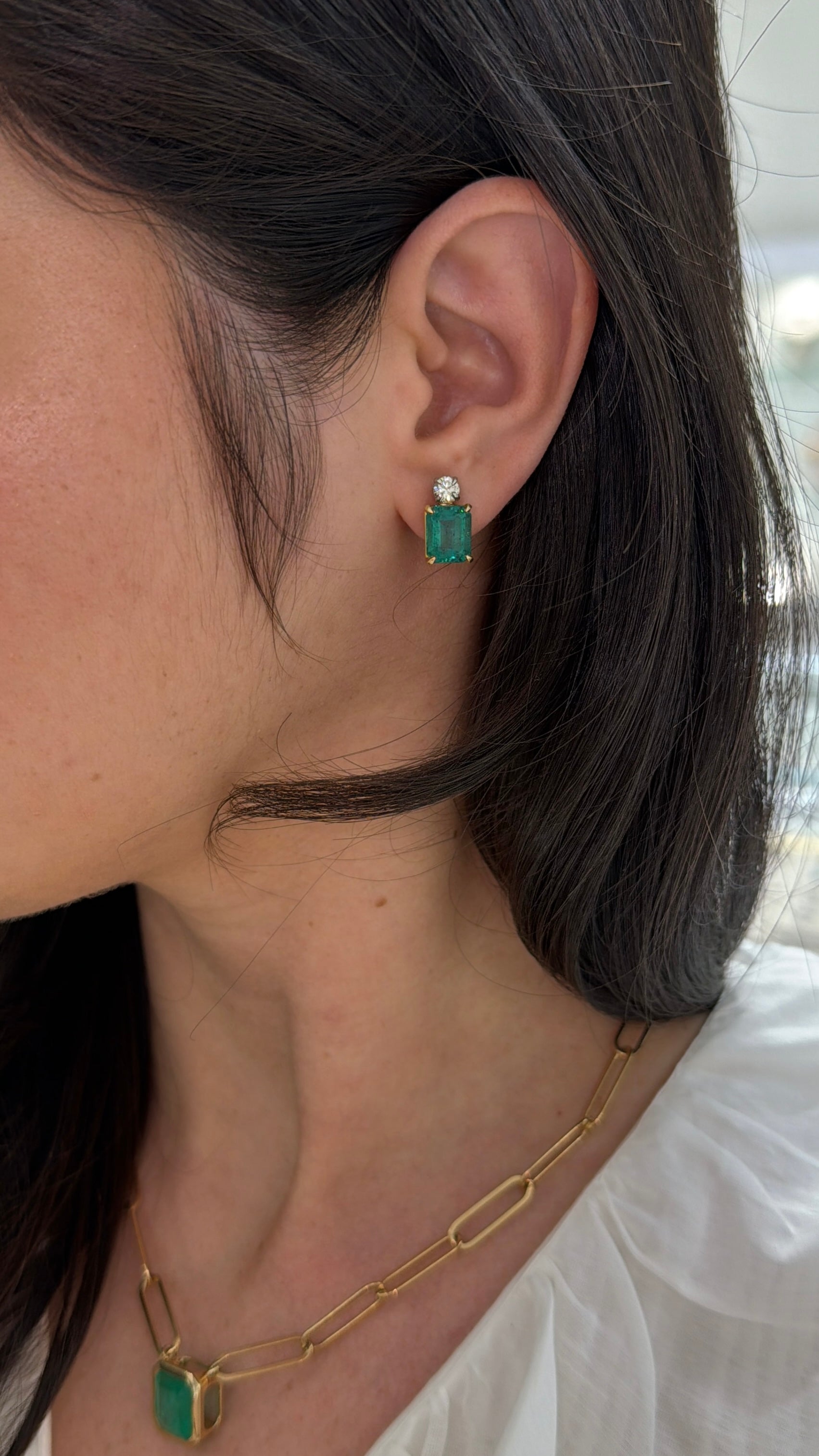 Colombian Emerald 7.20tcw 18K gold earrings featuring vivid bluish-green emerald-cut and round diamonds in two-tone design