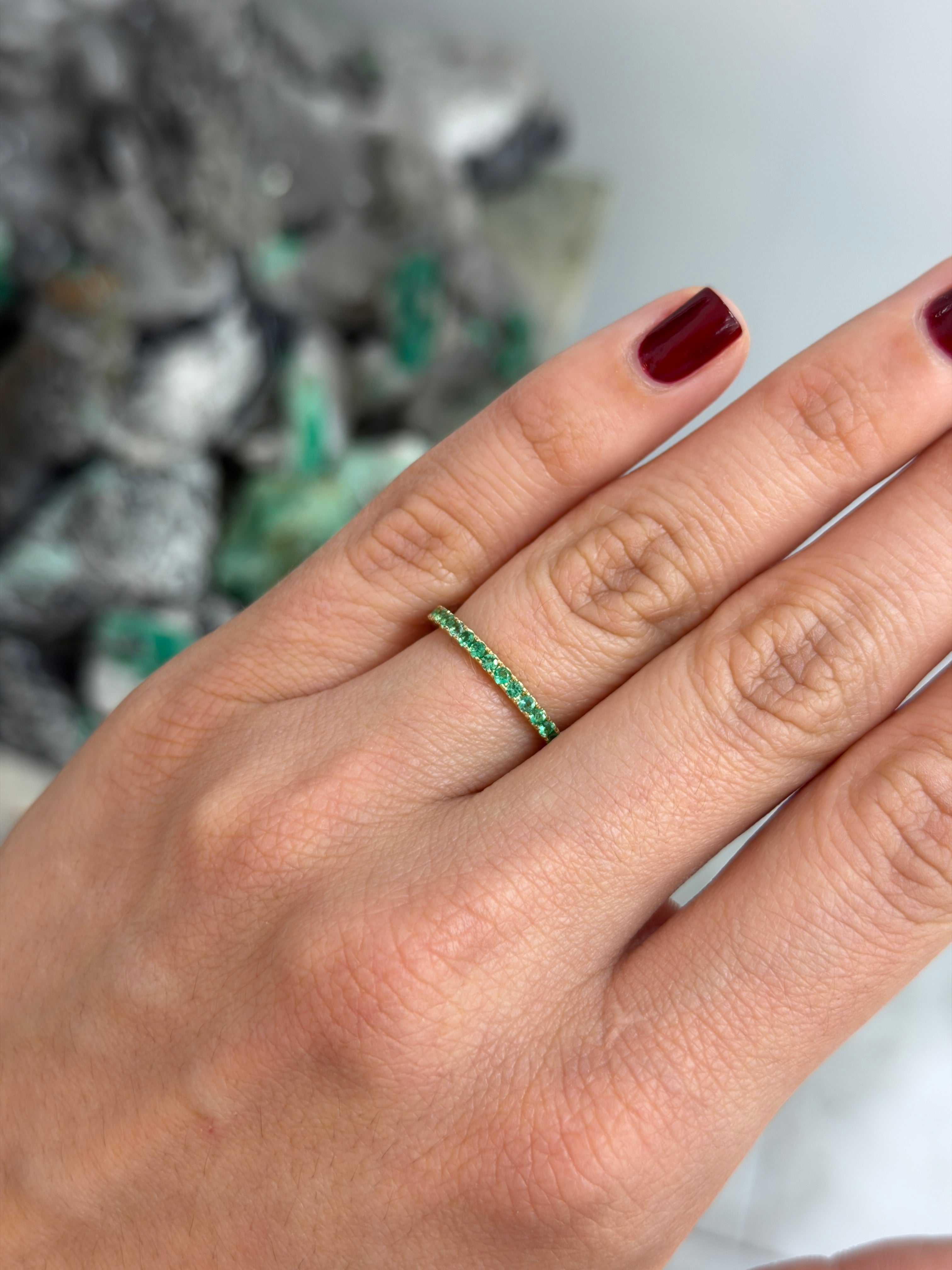 14K natural emerald eternity band with 0.70tcw from JR Colombian Emeralds, showcasing a continuous row of vibrant green emeralds.