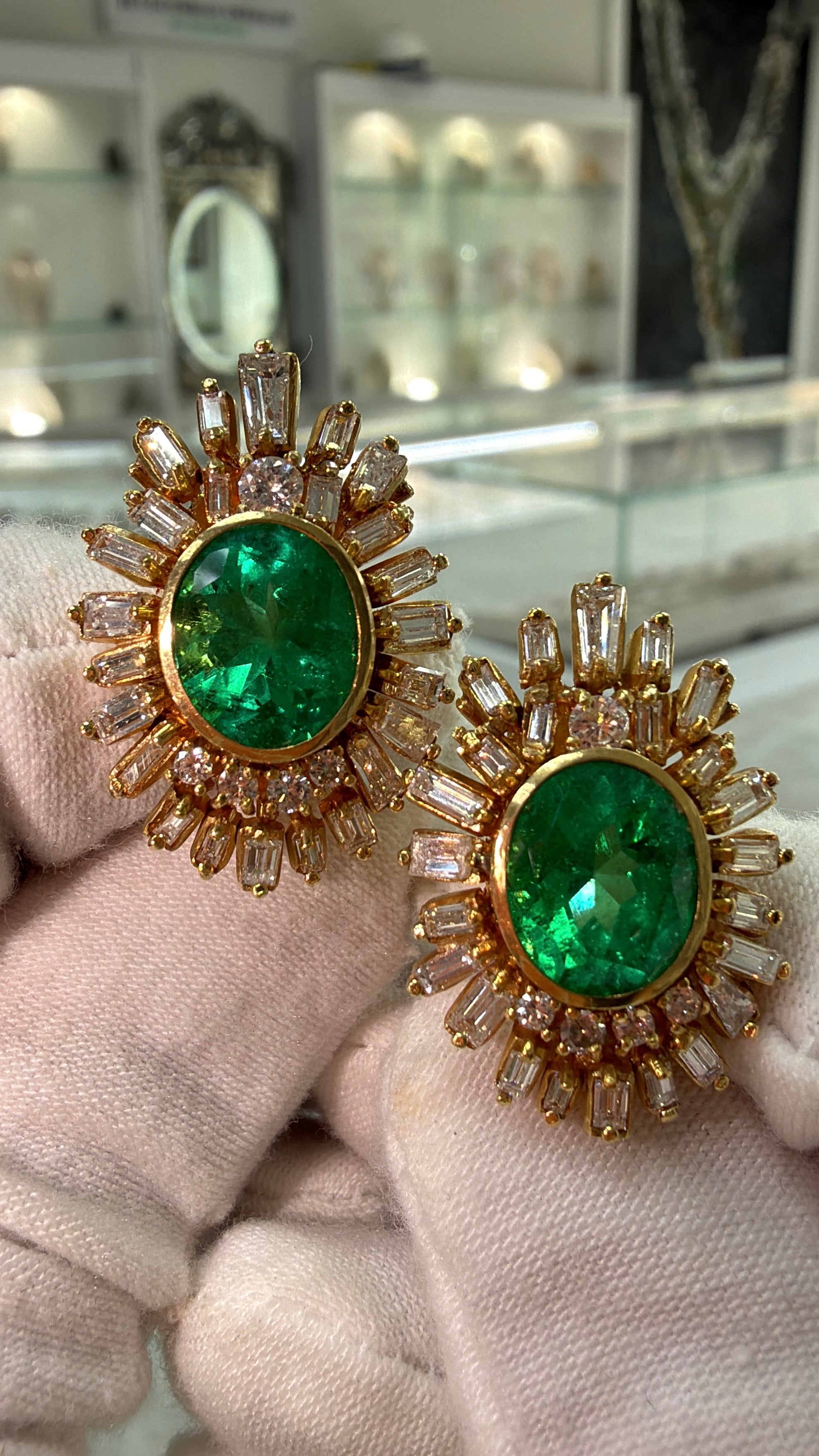 JR Colombian Emeralds 12.20tcw AAA+ oval Colombian emerald and diamond statement earrings with intricate gold settings.