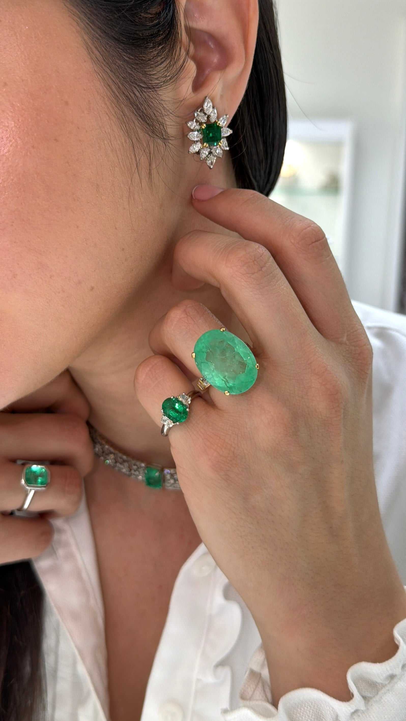 14K Colombian emerald and diamond statement ring featuring oval-cut emeralds and sparkling accents, designed for ladies.