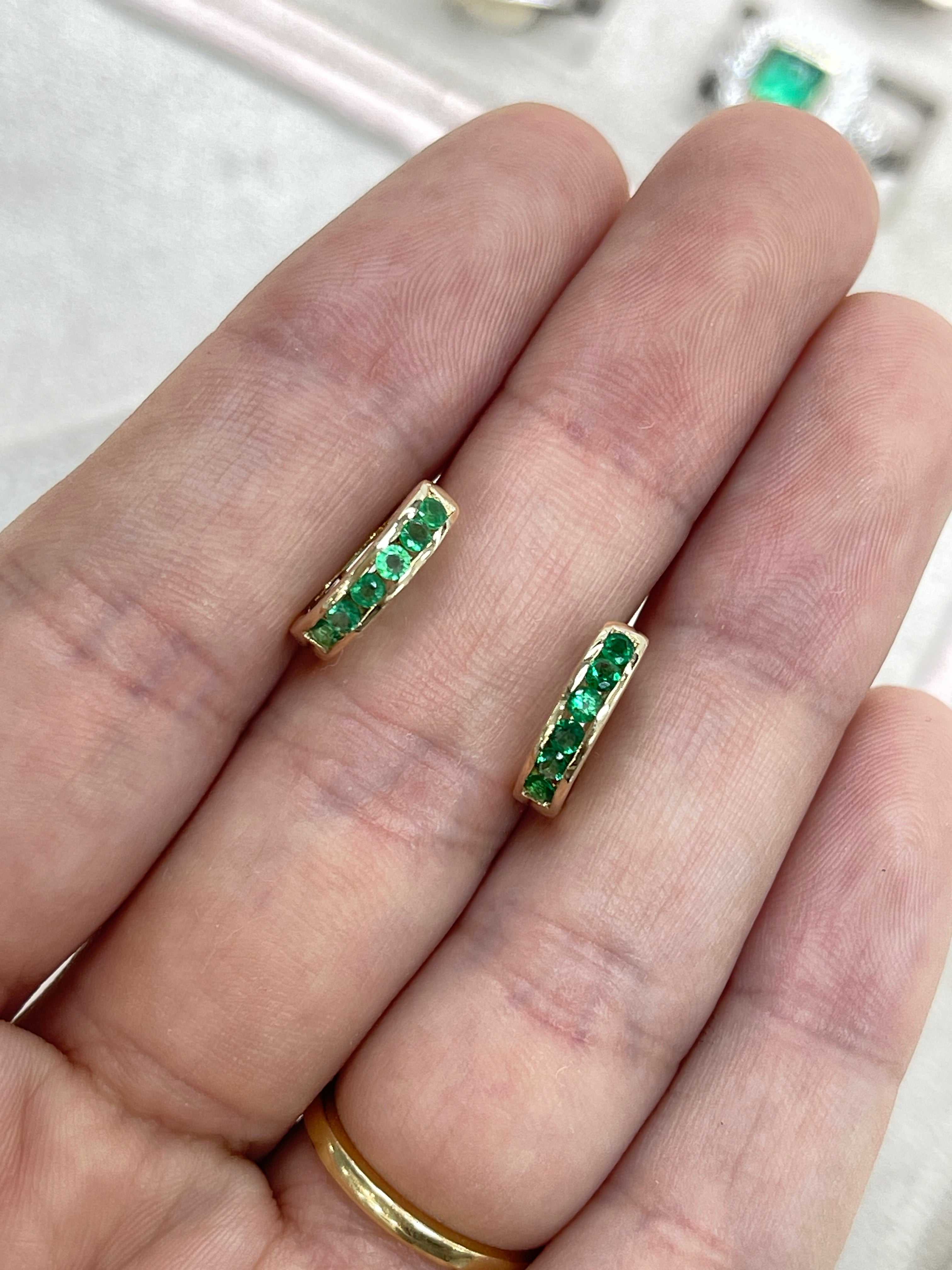 14K yellow gold emerald huggie hoop earrings with round green stones, 0.47 carats total weight