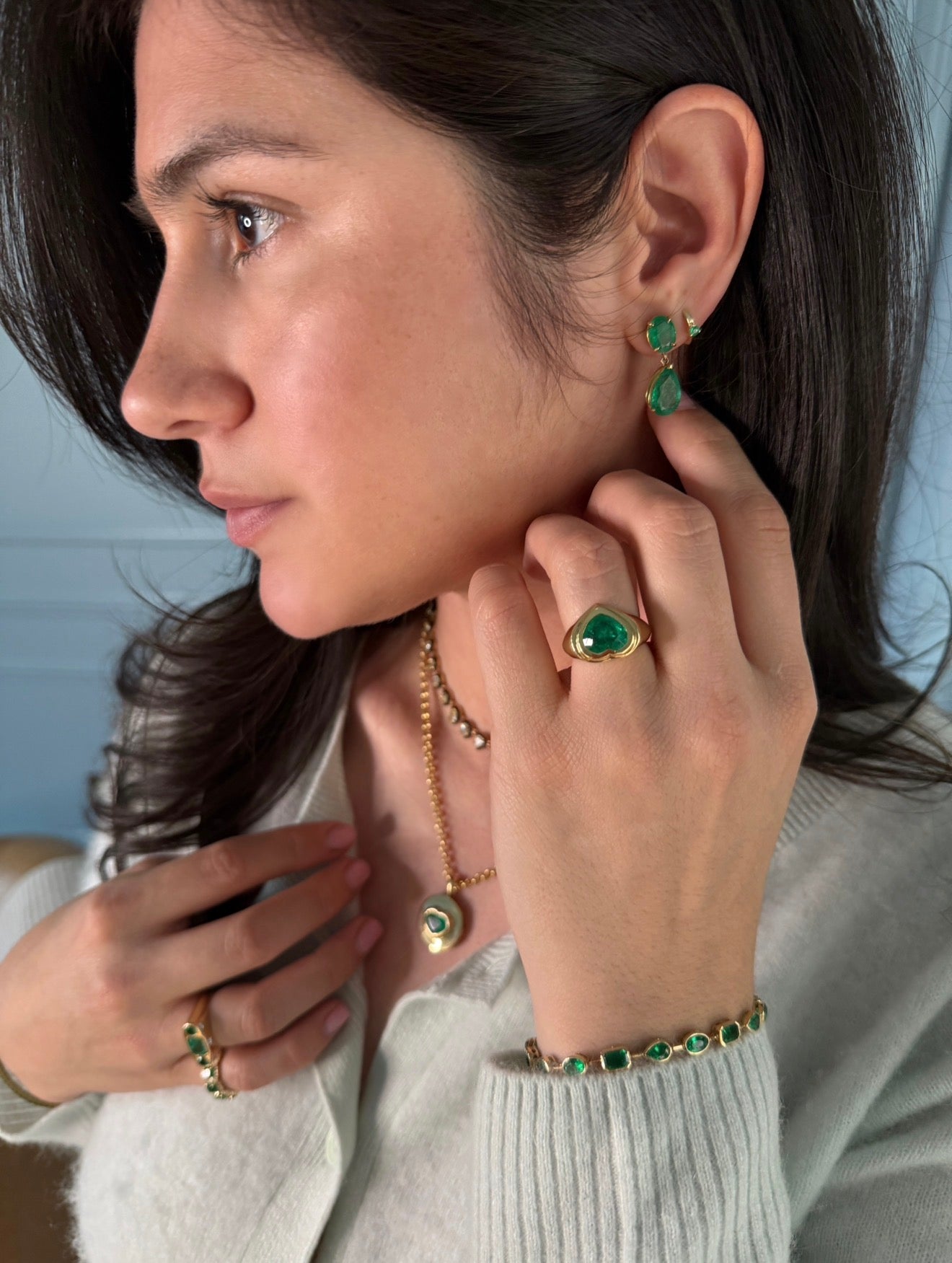 Colombian Emerald earrings featuring 9.78 carats of dark green oval and pear-shaped dangles in 18K gold.