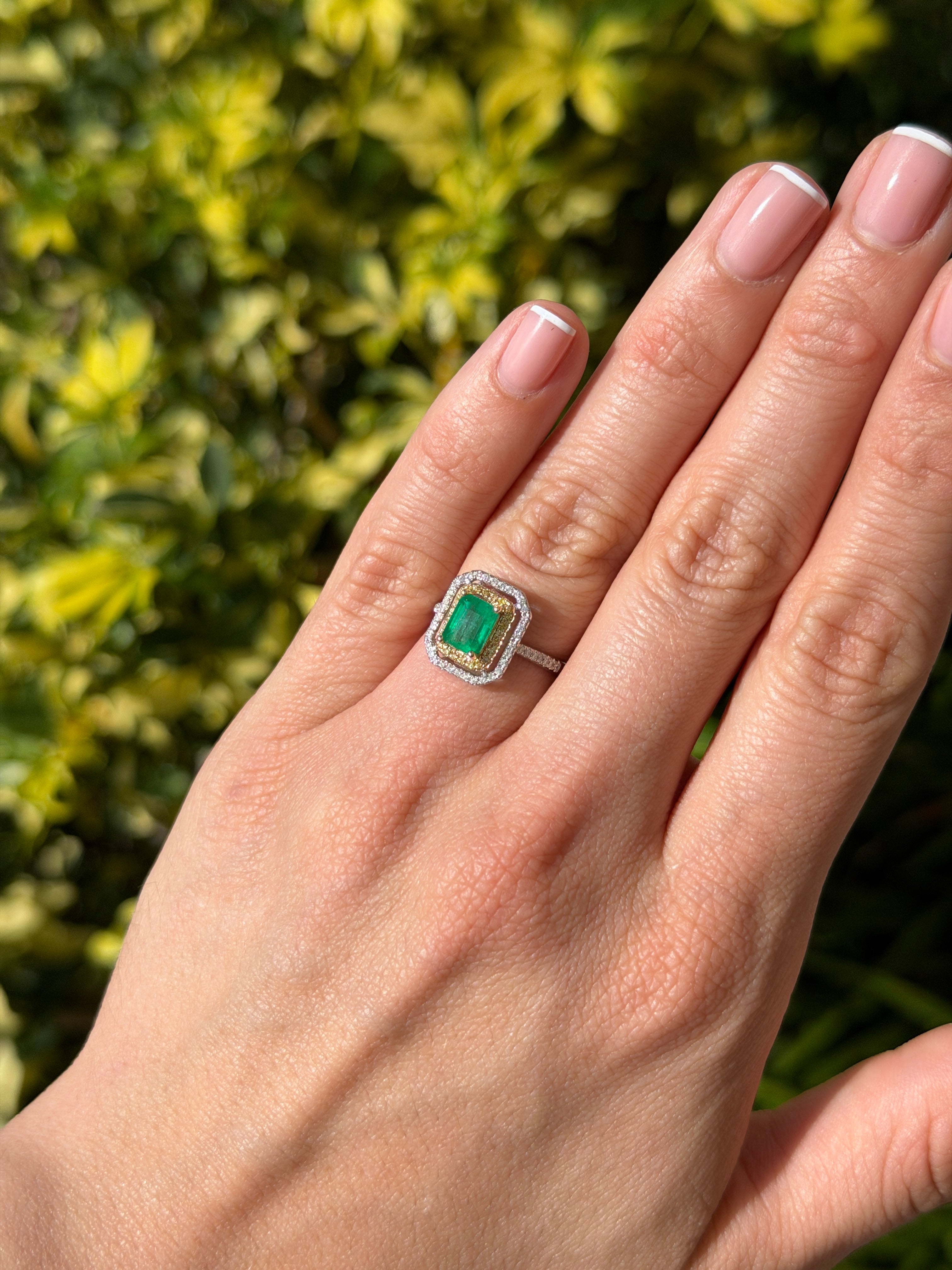 14K gold Colombian emerald and yellow diamond halo ring with 1.65 tcw, showcasing vibrant gemstones and intricate design.