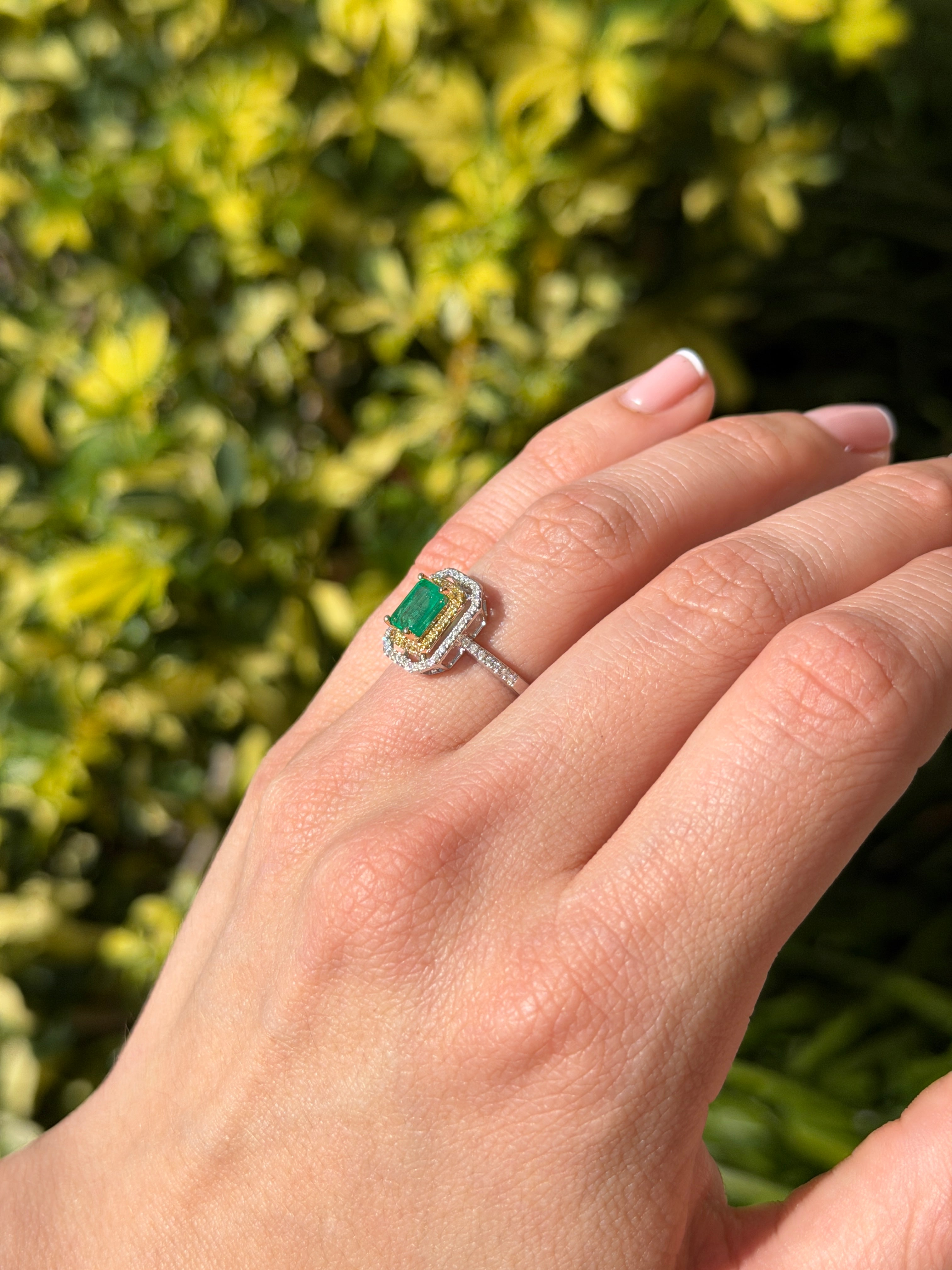 14K gold Colombian emerald and yellow diamond halo ring with 1.65tcw gemstones, featuring a central emerald and diamond accents.