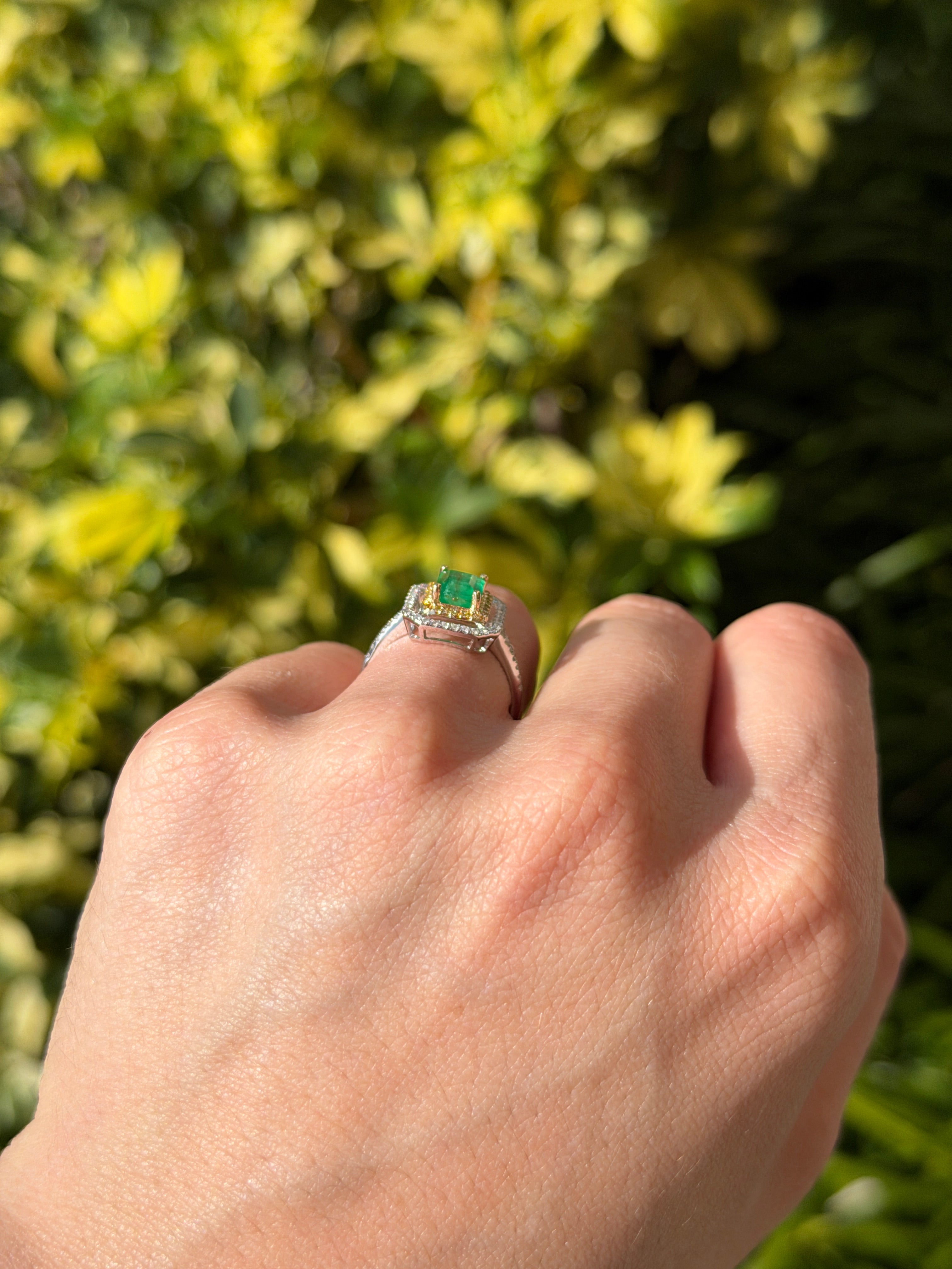 14K gold Colombian emerald and yellow diamond halo ring with 1.65tcw gemstones, featuring a stunning central emerald.