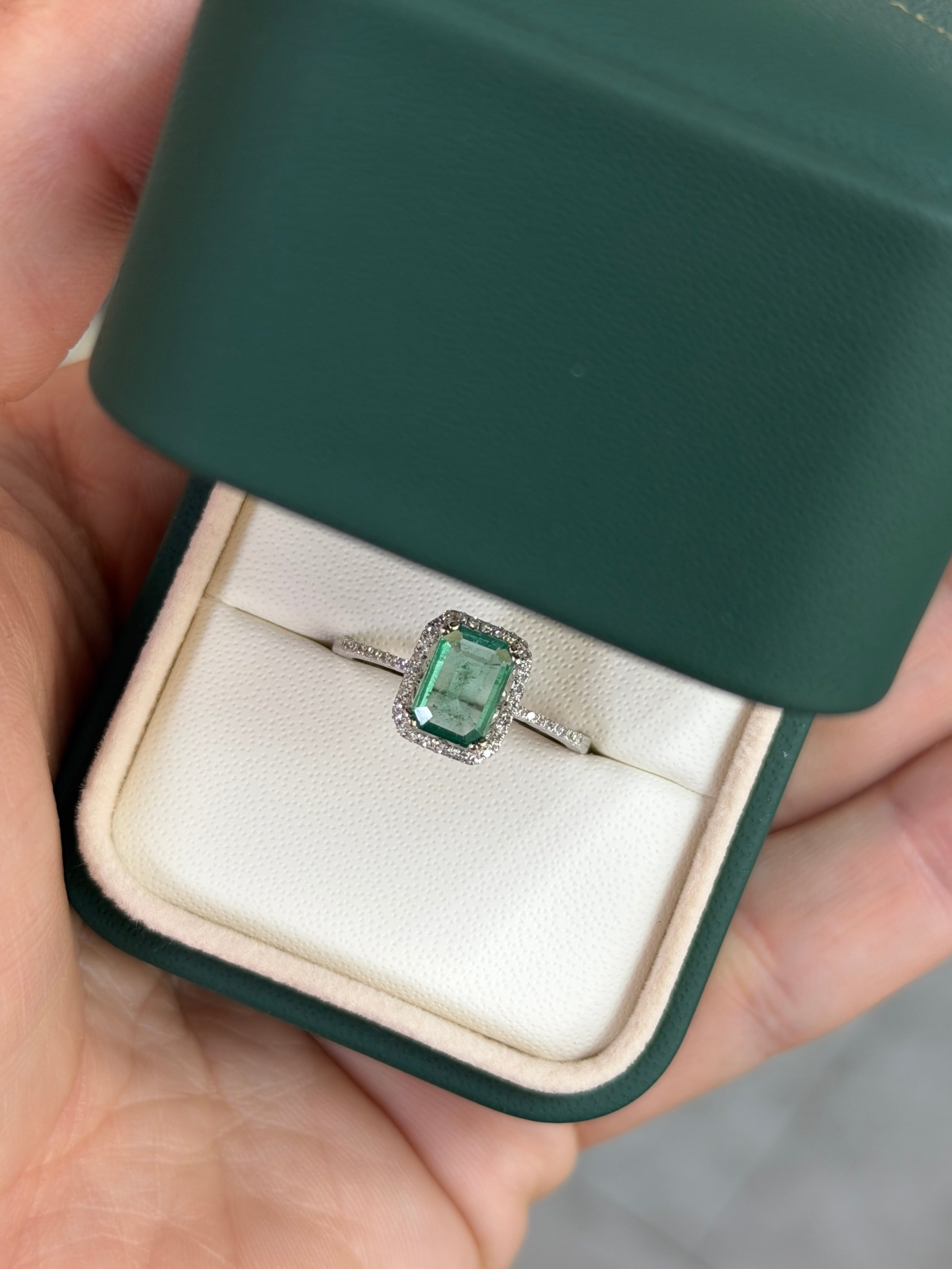 10x7.5mm emerald and diamond halo engagement ring in 14K white gold with crystal-clear stones, by JR Colombian Emeralds.