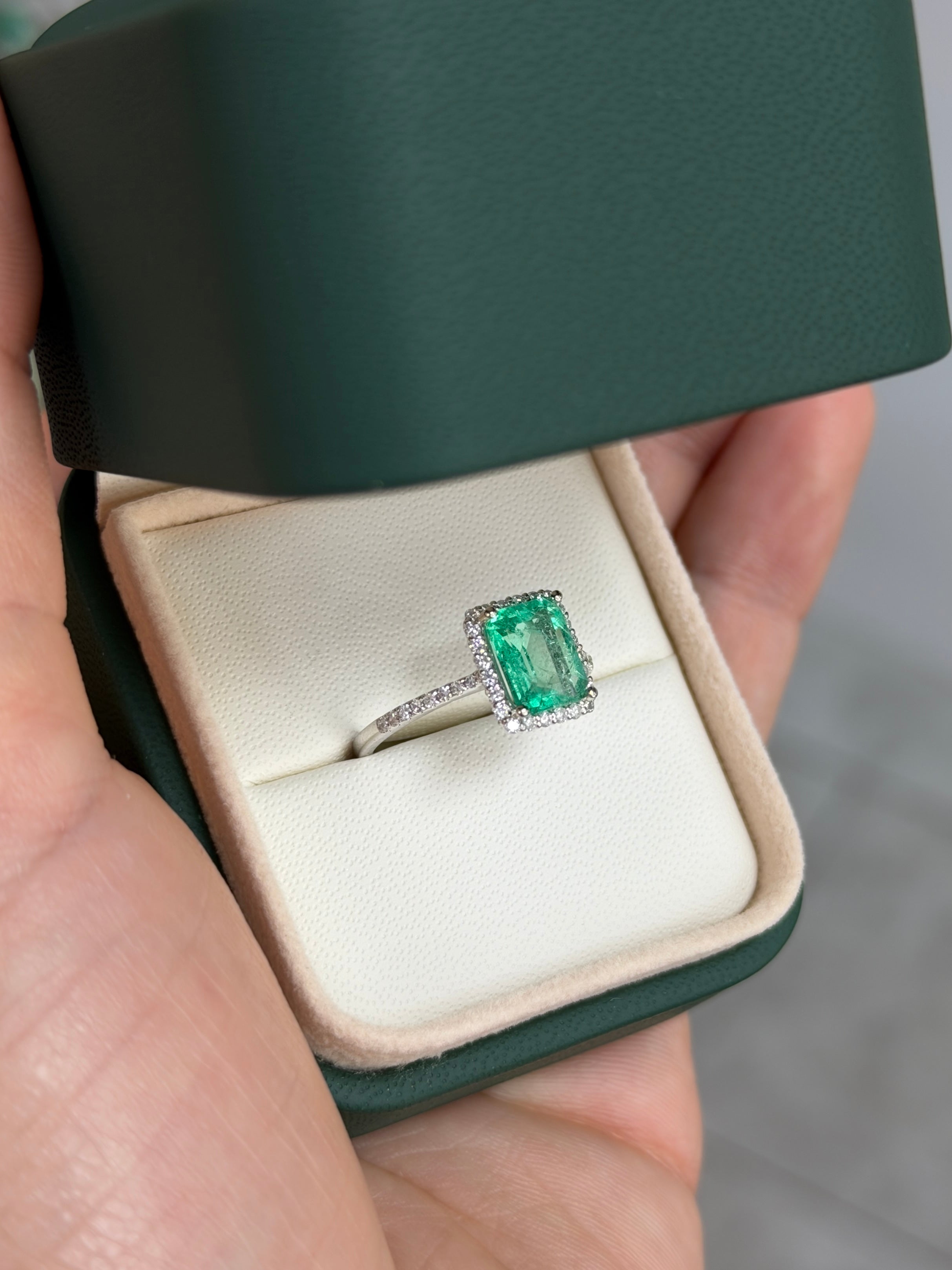 1.70tcw Colombian emerald and diamond halo engagement ring in 14K white gold from JR Colombian Emeralds, showcasing the intricate design.