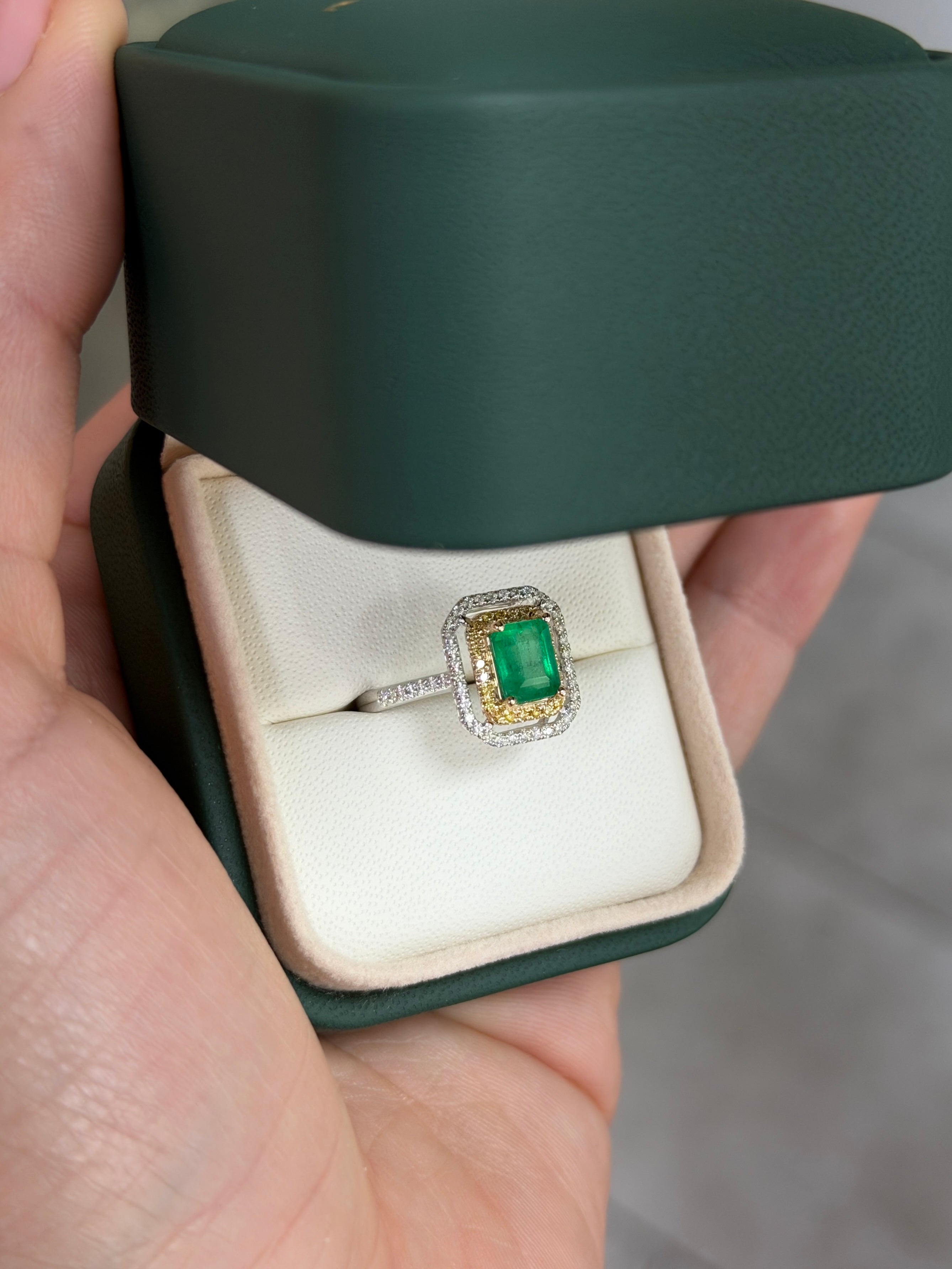 14K gold halo ring featuring 1.65 tcw Colombian emerald and yellow diamond accents, showcasing a vibrant and elegant design.