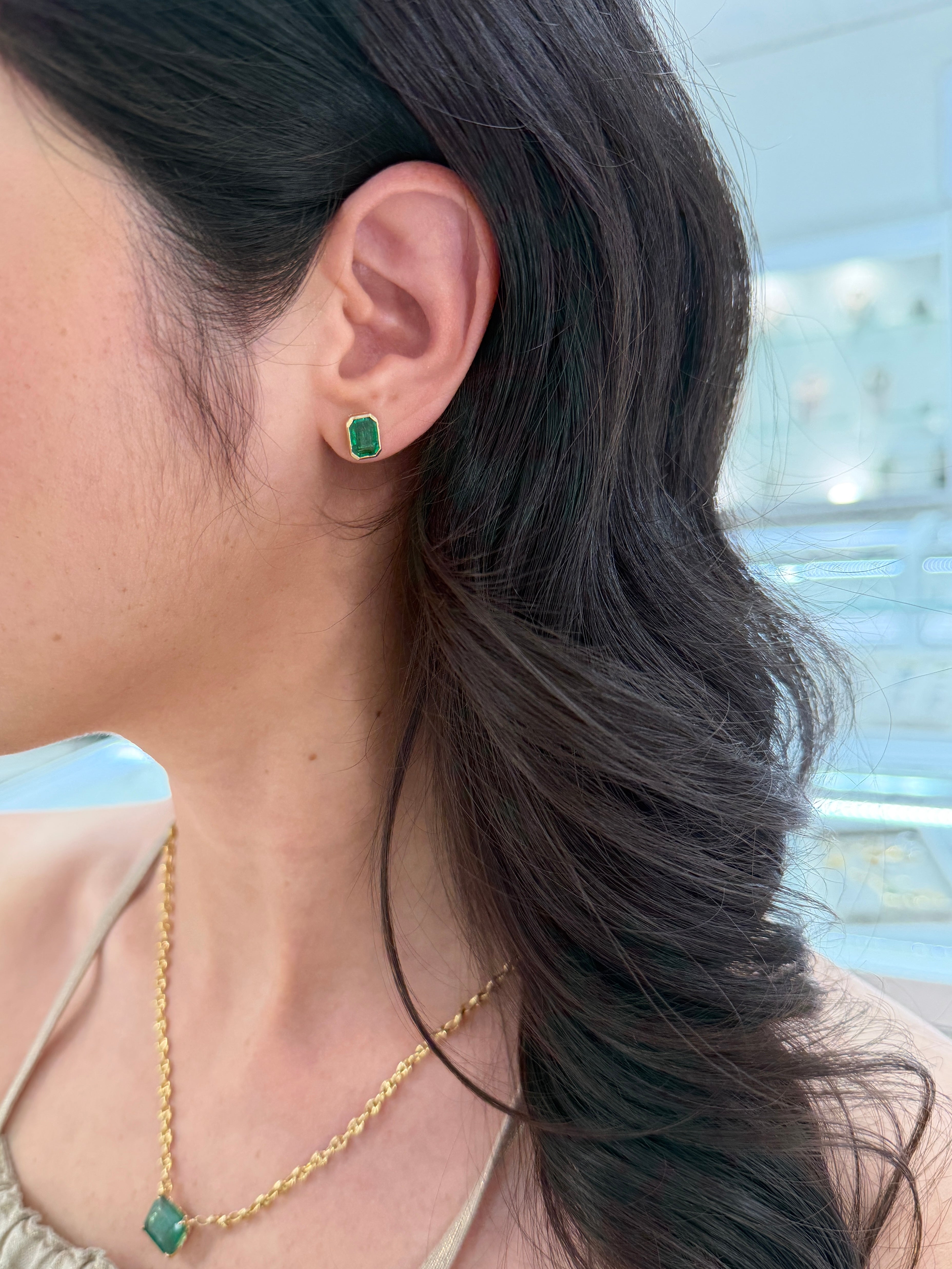 JR Colombian Emeralds 3.33tcw Angelina Jolie bezel set emerald stud earrings in 18K gold, featuring vibrant green emeralds.