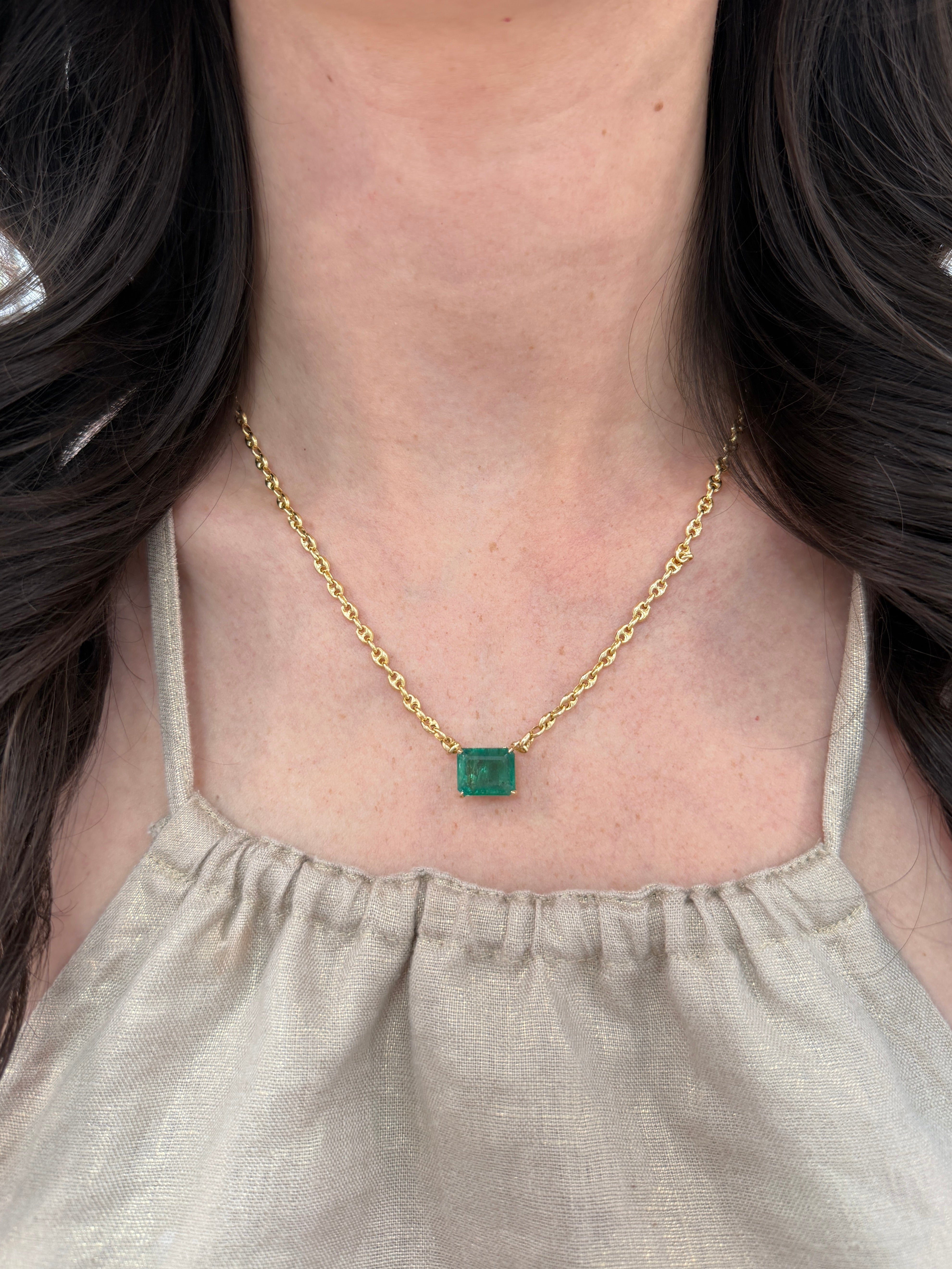 7.30 carat east-to-west emerald Gucci link necklace in 14K gold, featuring solid emerald accents, 20-inch length.