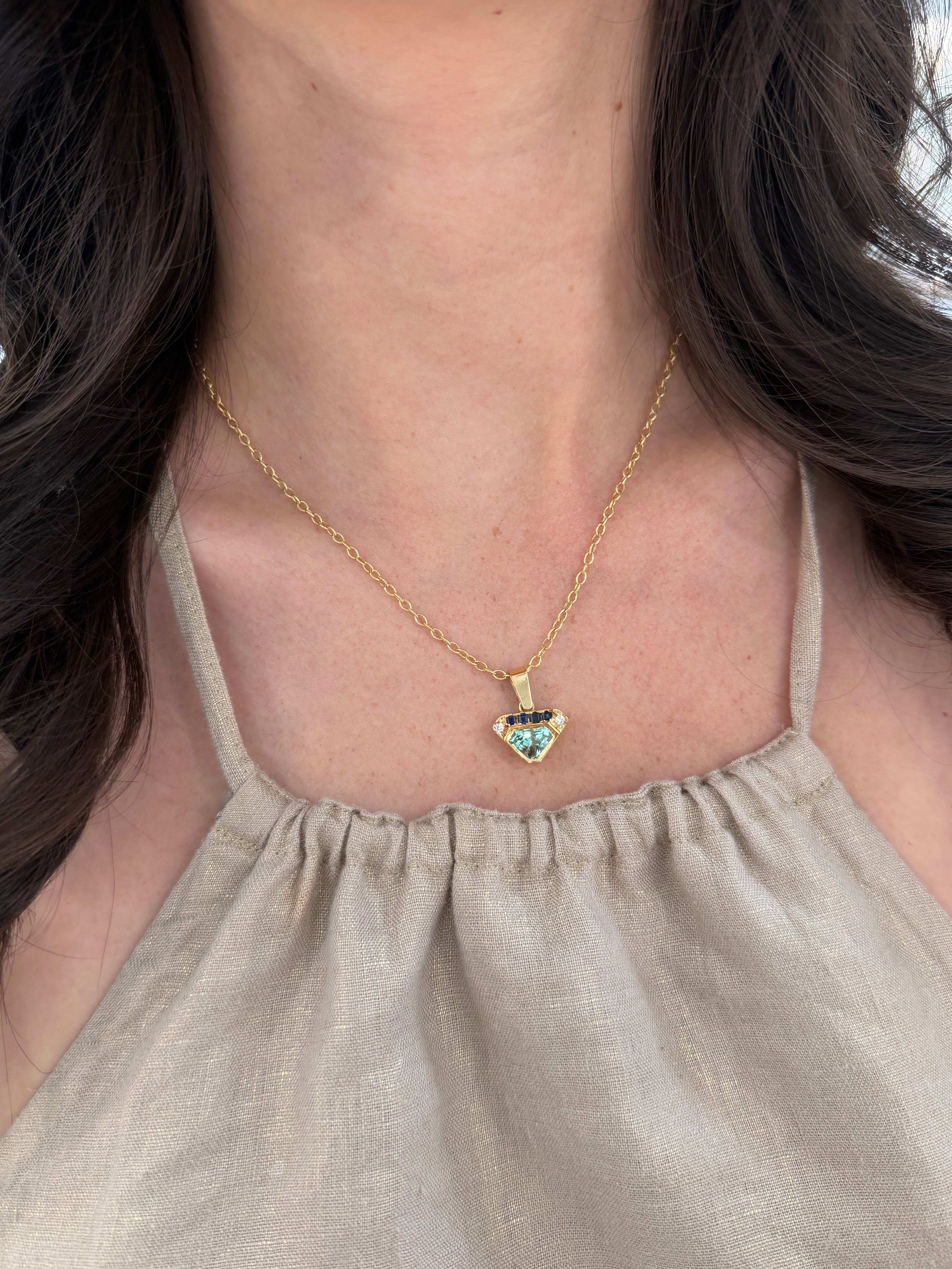 VVS clarity Colombian emerald shield pendant with blue sapphire and diamonds, featuring 2.80 carats total weight, by JR Colombian Emeralds