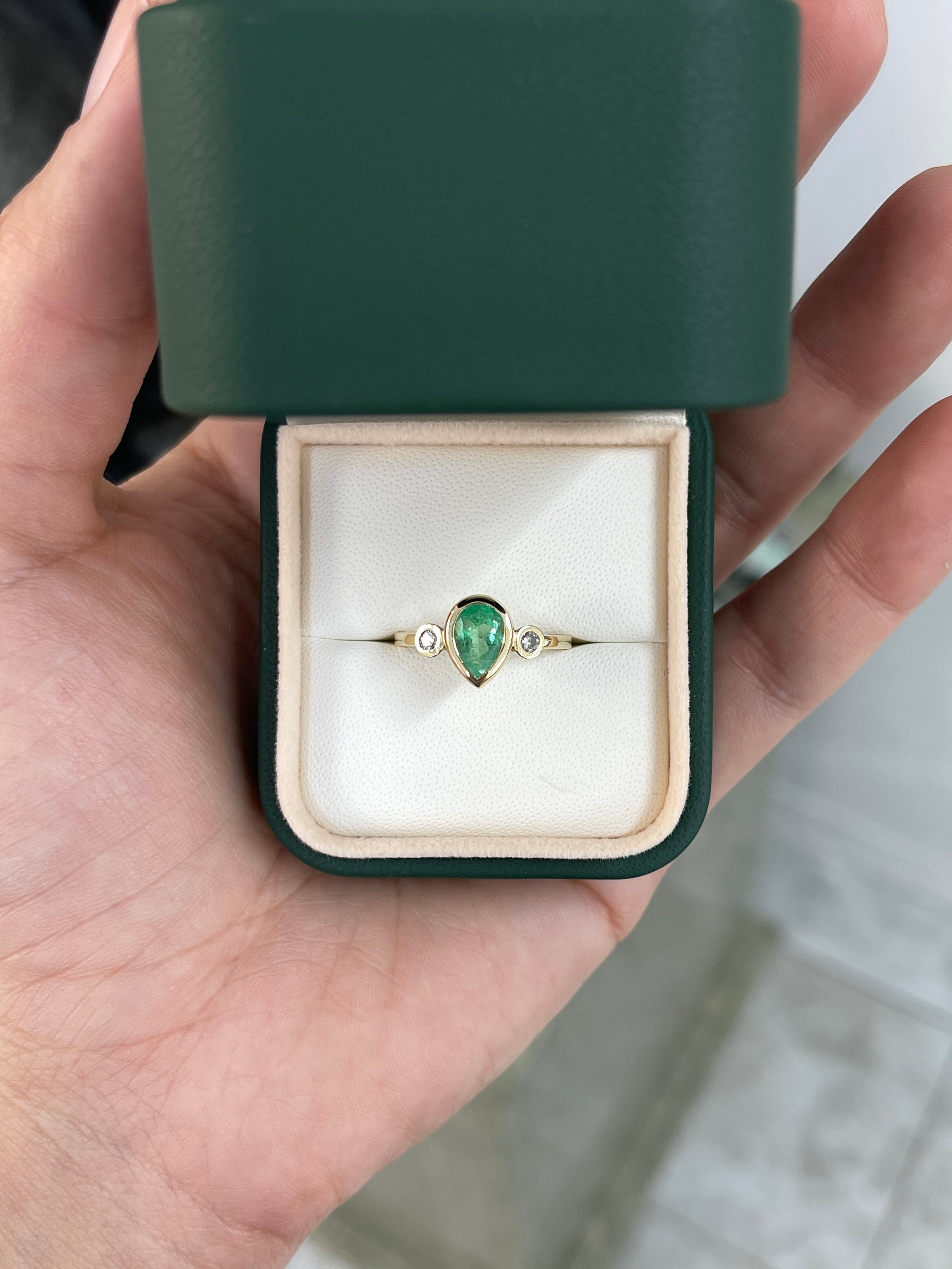 Bezel set tear drop natural emerald and diamond three-stone engagement ring in 14k gold by JR Colombian Emeralds.