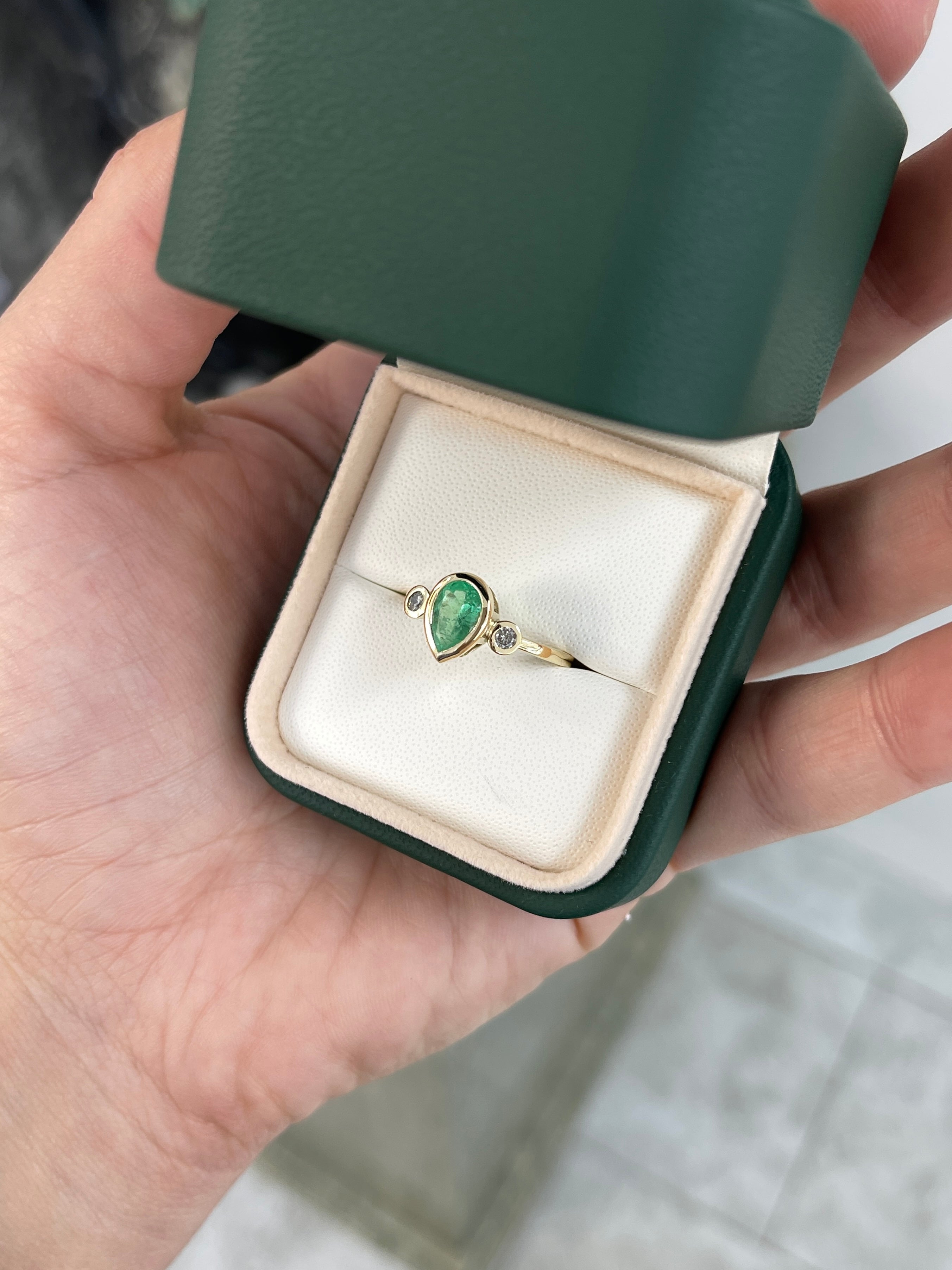 Bezel set tear drop natural emerald and diamond three-stone engagement ring in 14k gold by JR Colombian Emeralds.