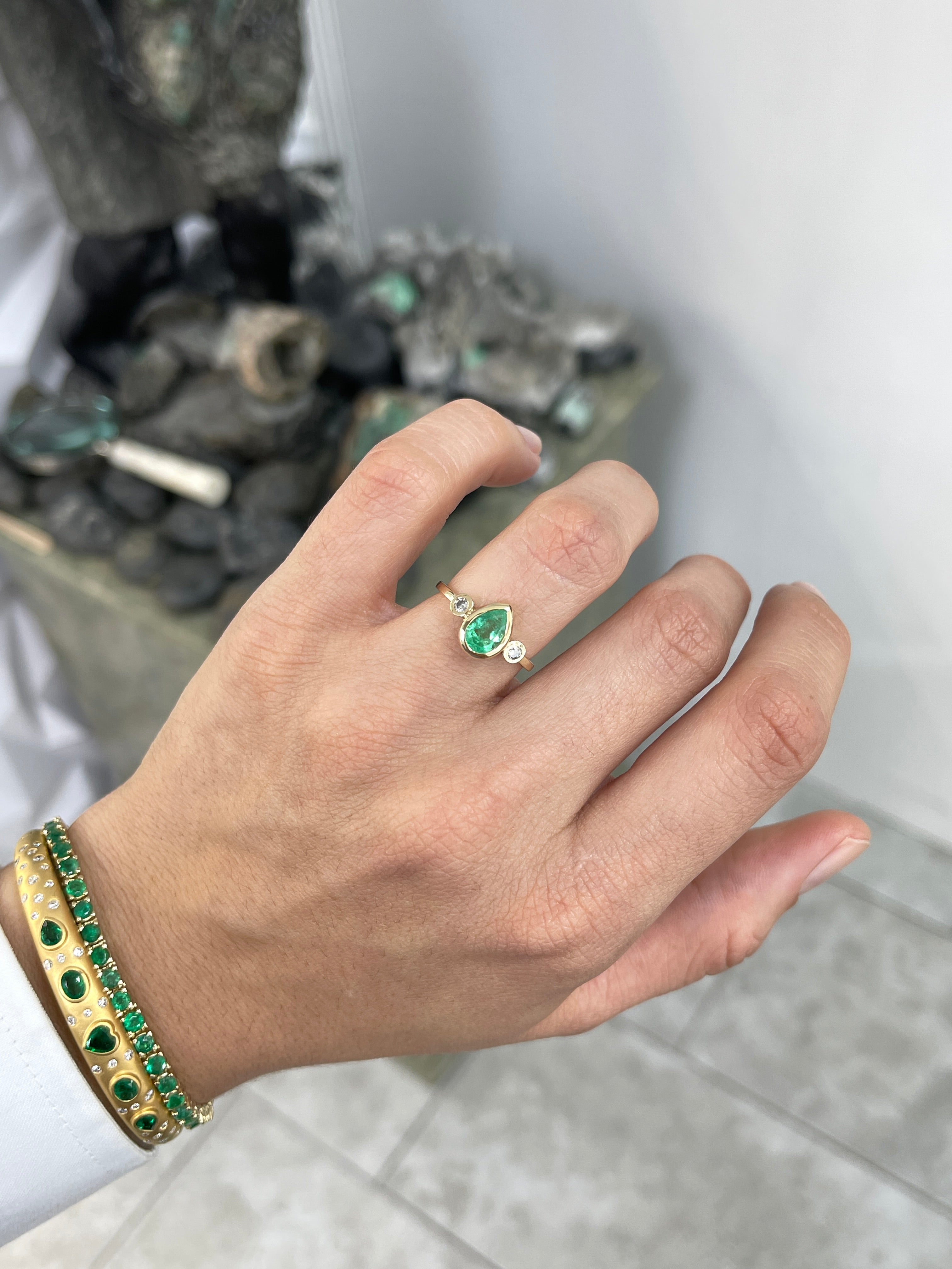 Bezel set tear drop natural emerald and diamond three stone engagement ring in 14k gold by JR Colombian Emeralds.