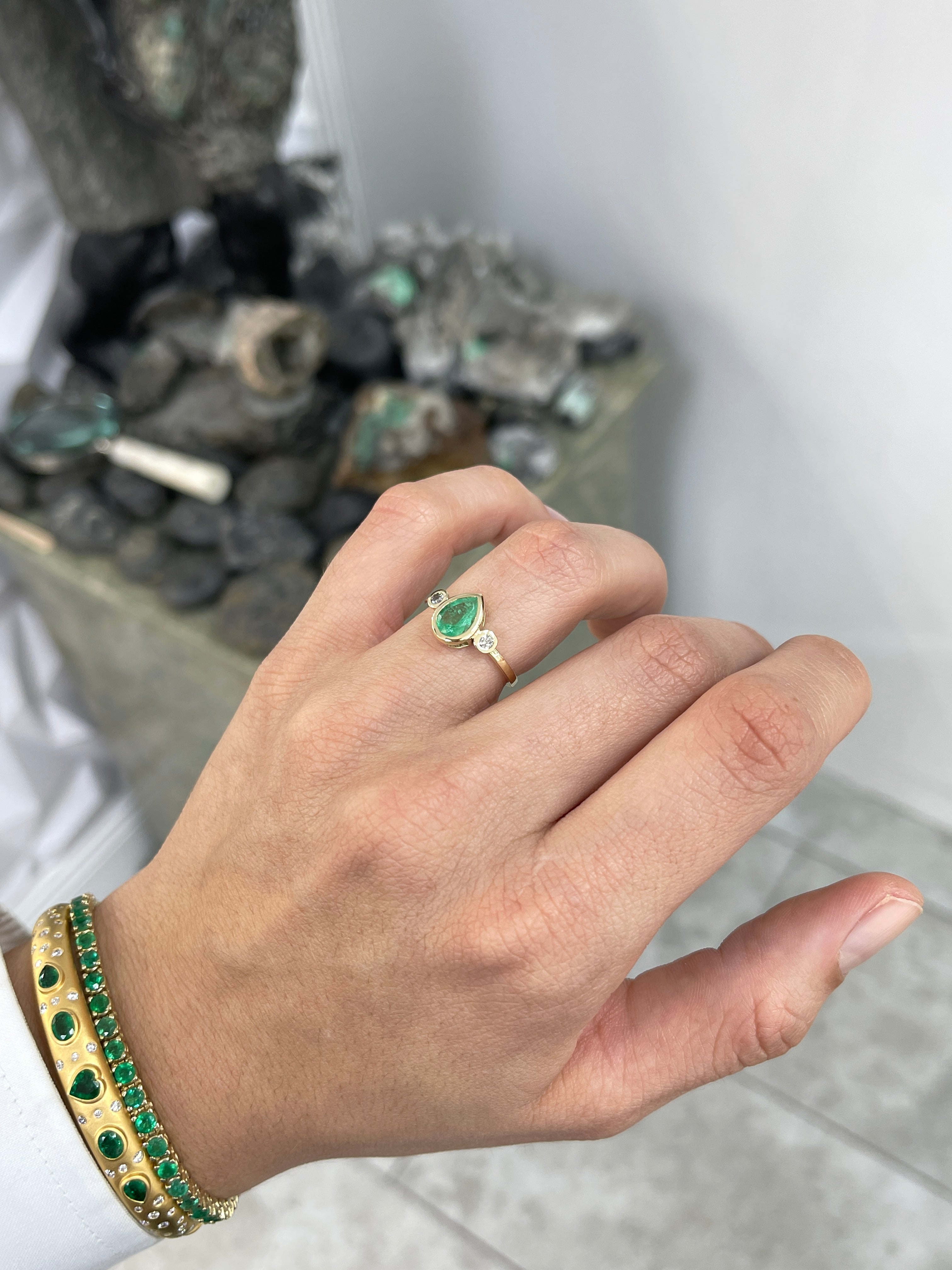 Bezel set tear drop natural emerald and diamond engagement ring with three stones in 14k gold by JR Colombian Emeralds.