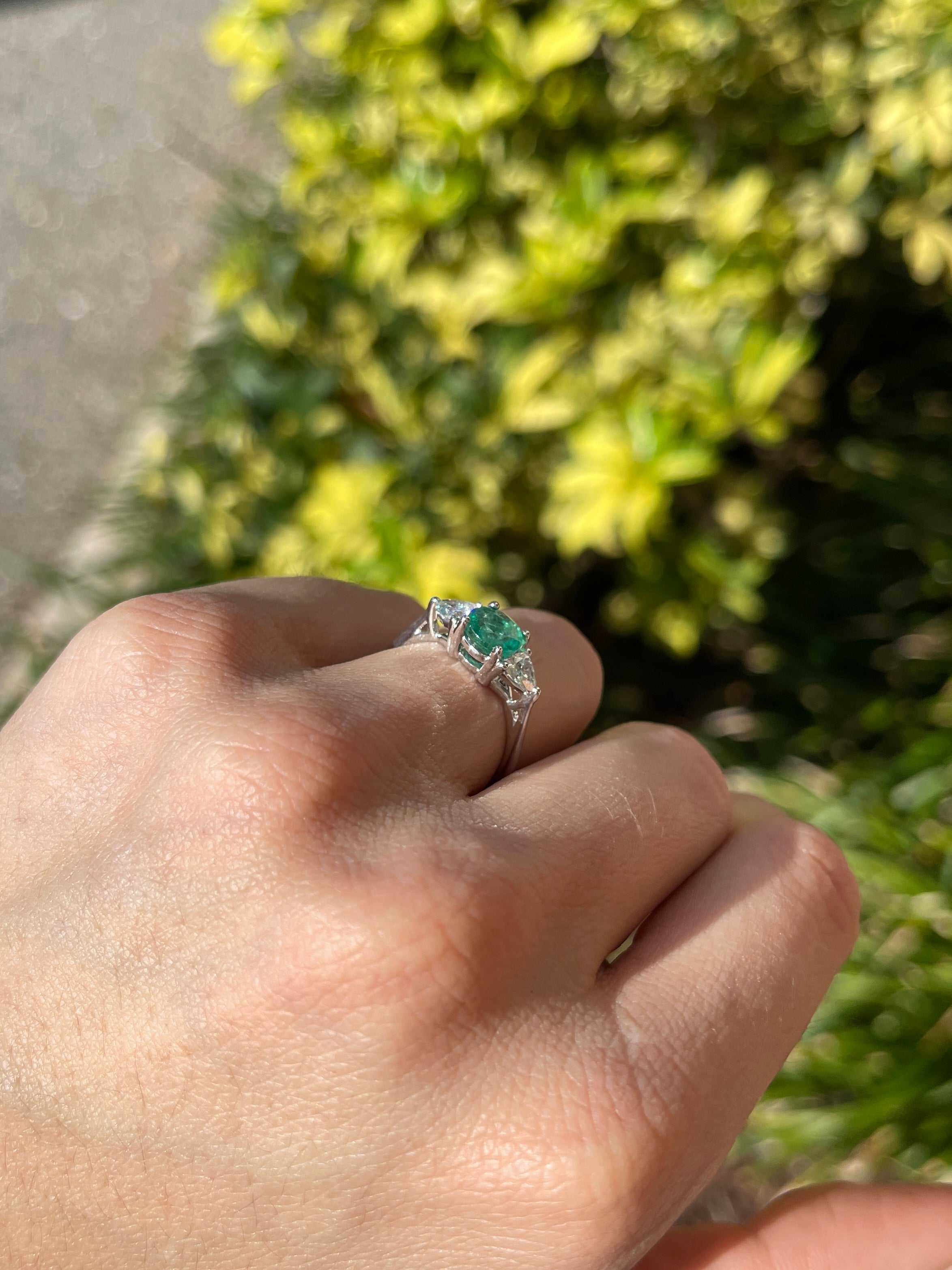 Natural round emerald and trillion lab diamond three-stone ring in 14K gold by JR Colombian Emeralds, showcasing sparkling gemstones.