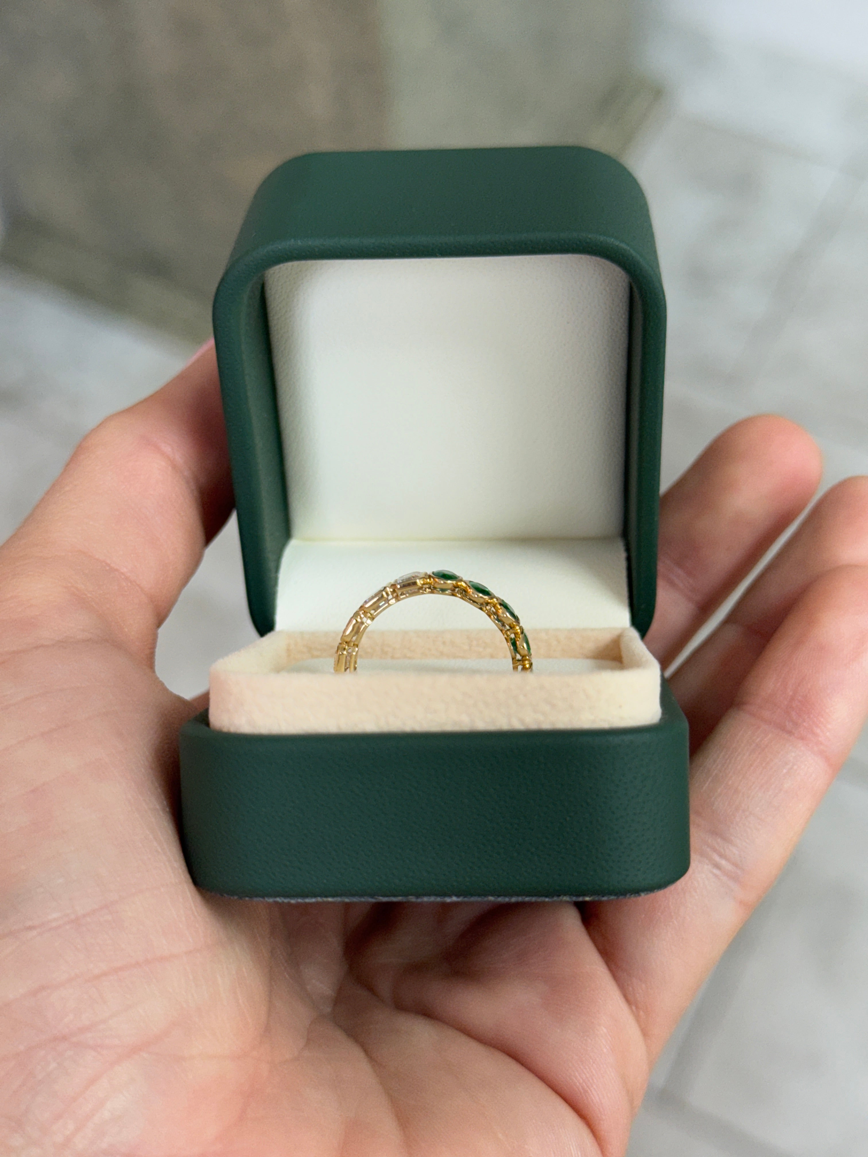 JR Colombian Emeralds 3.65tcw half oval and emerald cut diamond eternity band in 18K gold, size 6.5, showcasing sparkling gemstone design.