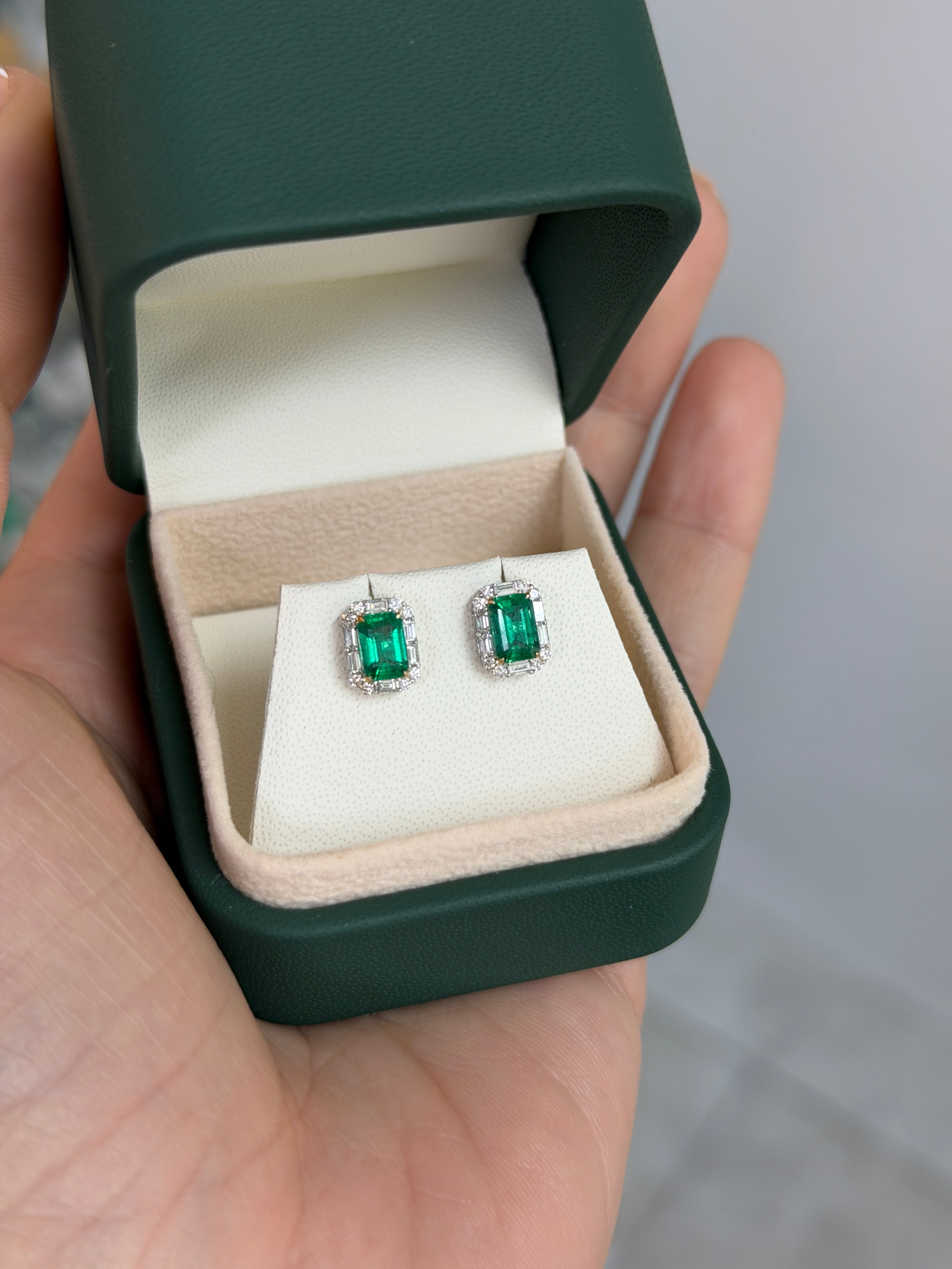Natural emerald and baguette diamond halo stud earrings in 18K two-tone gold, featuring fine quality gemstones by JR Colombian Emeralds