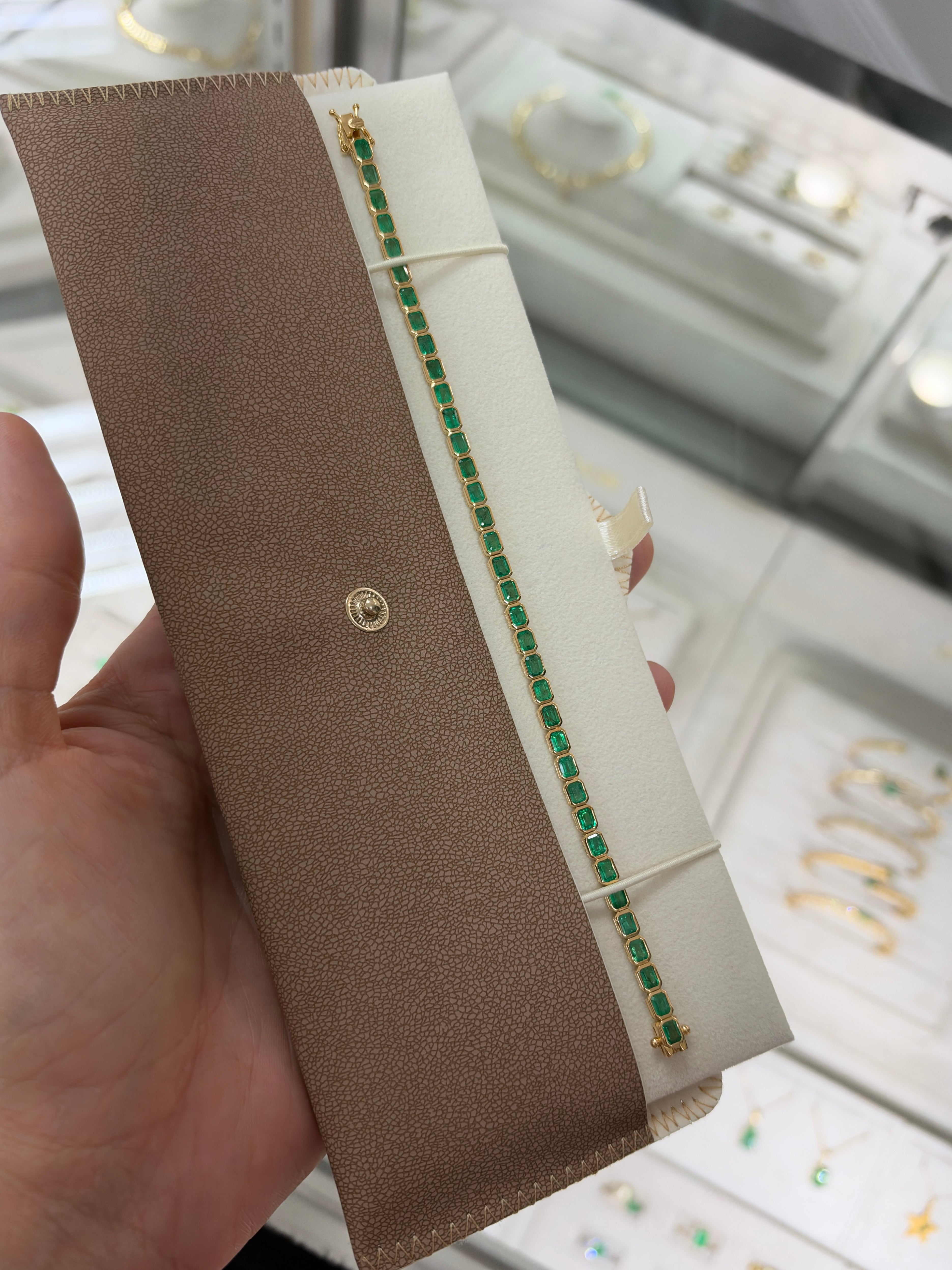 14K gold emerald tennis bracelet with 6.69tcw east-to-west bezel set Colombian emeralds, elegant jewelry by JR Colombian Emeralds.