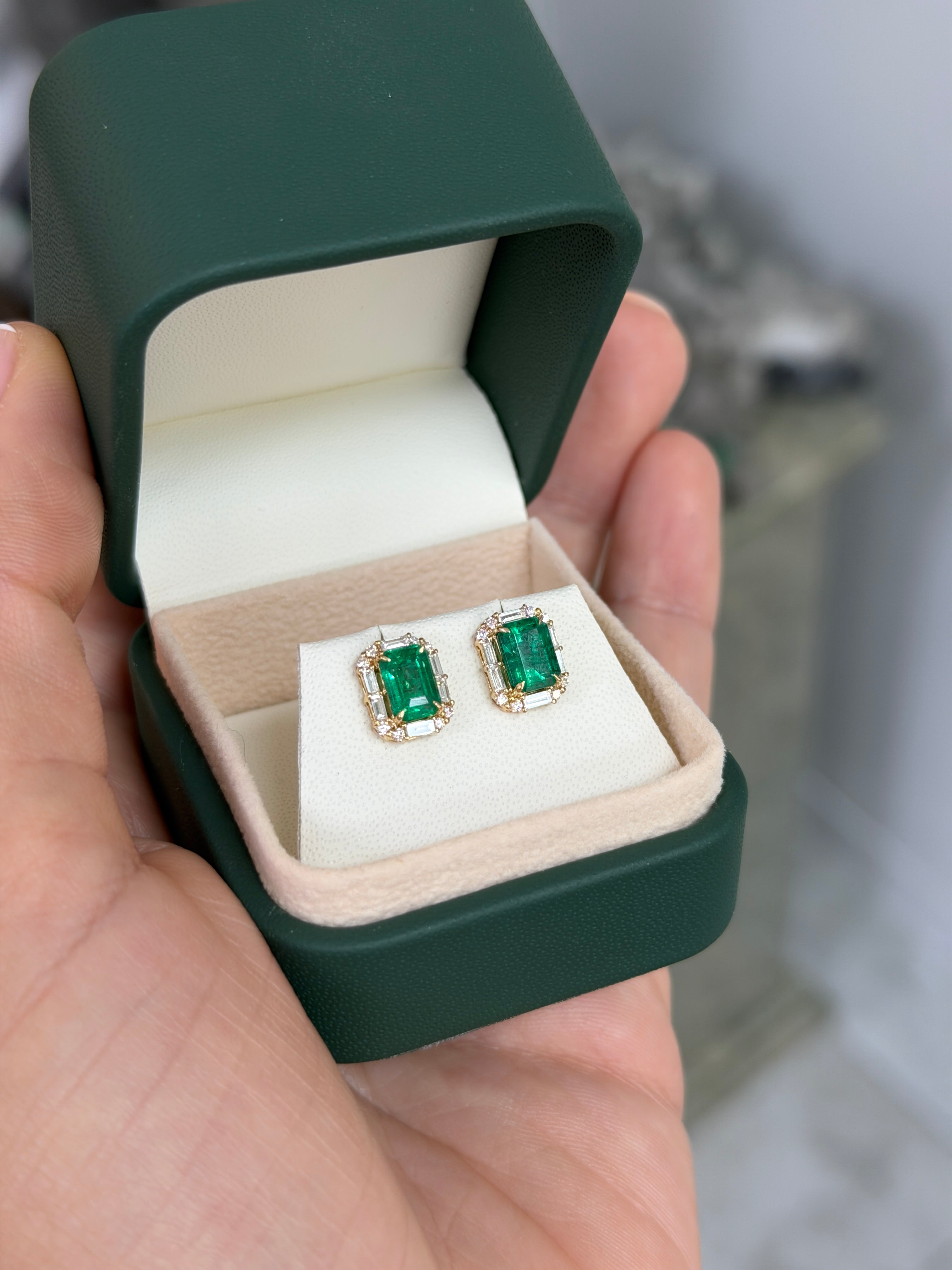 Emerald and diamond halo stud earrings featuring 2.55 carats total weight in rich green emeralds and baguette diamonds by JR Colombian Emeralds.