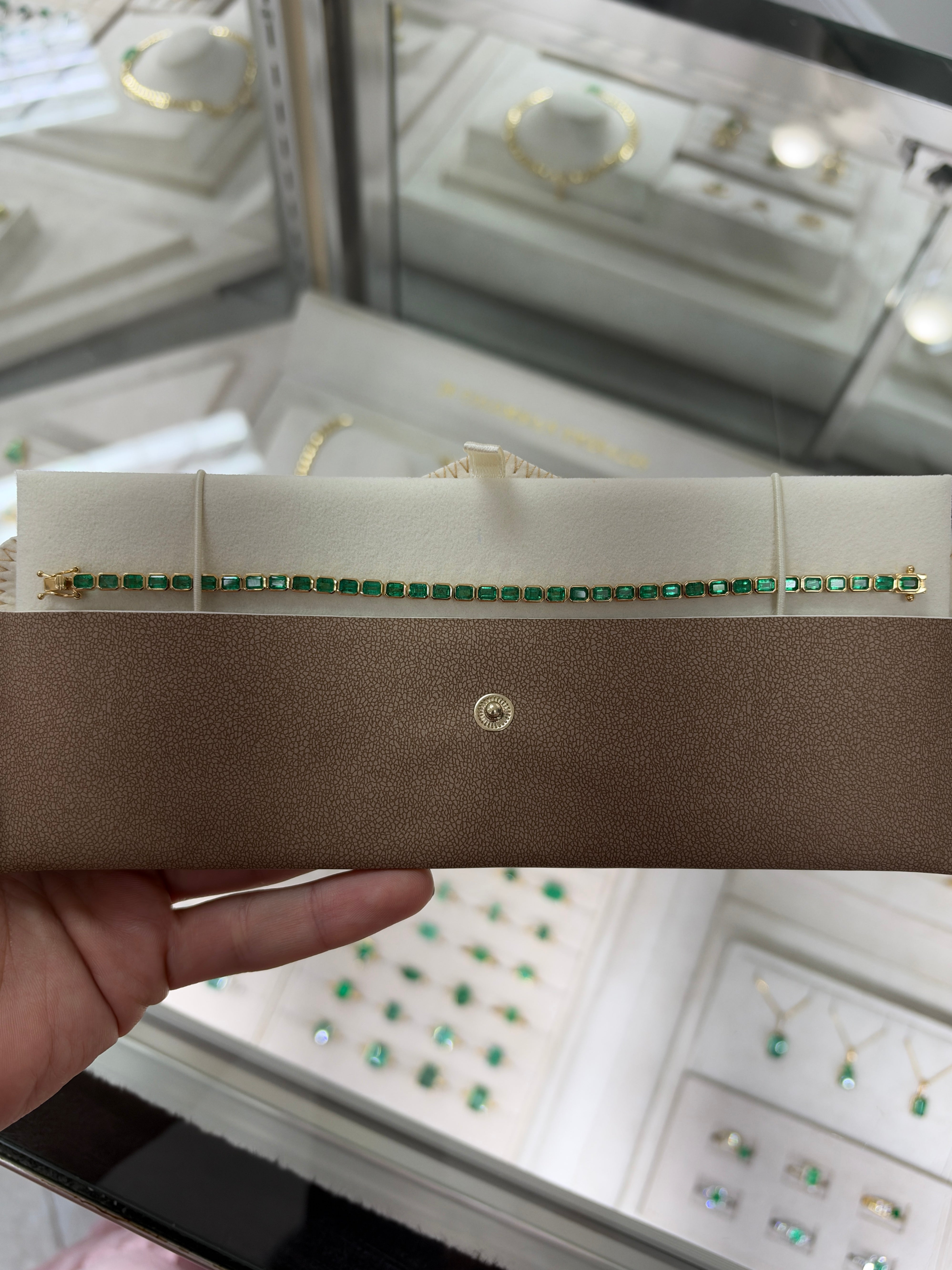 14K gold emerald tennis bracelet with 6.69 carats of east-west bezel-set emeralds, by JR Colombian Emeralds.